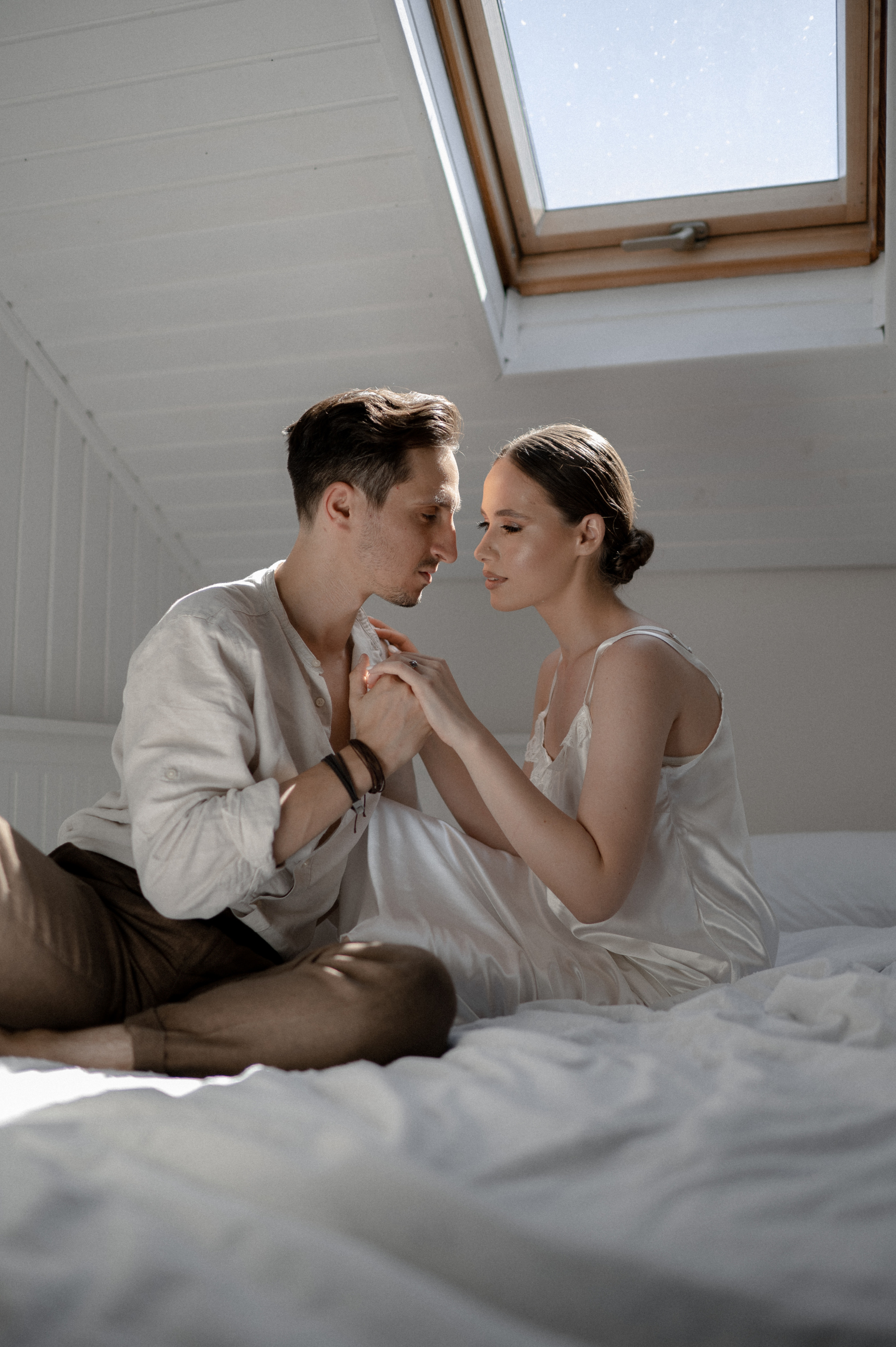 Blissful morning embrace as newlyweds savor intimate moments in bed, cherishing love and excitement for their wedding day.