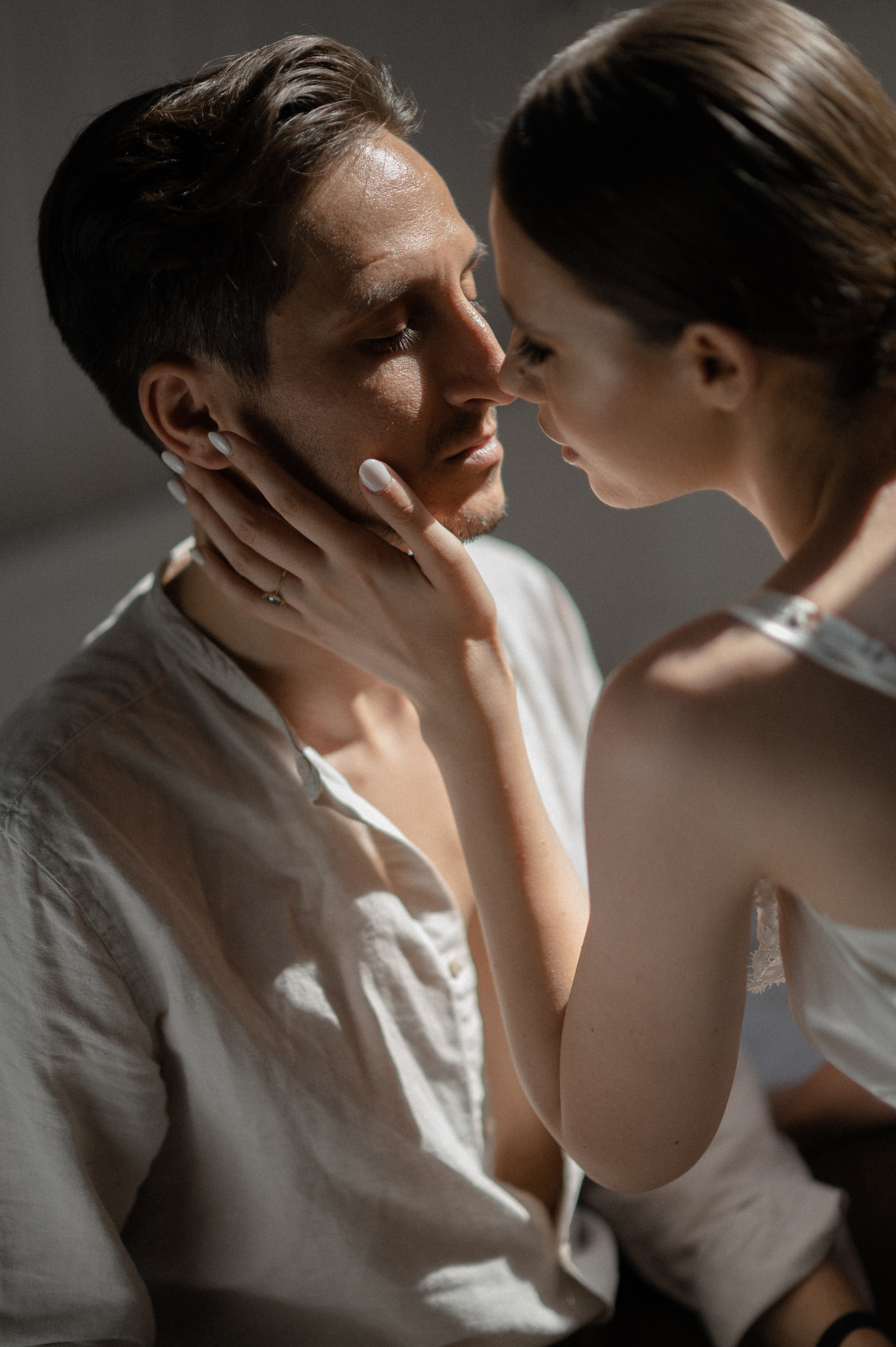 The couple finds solace in each other's arms, savoring tender moments in bed on their wedding morning, brimming with anticipation.