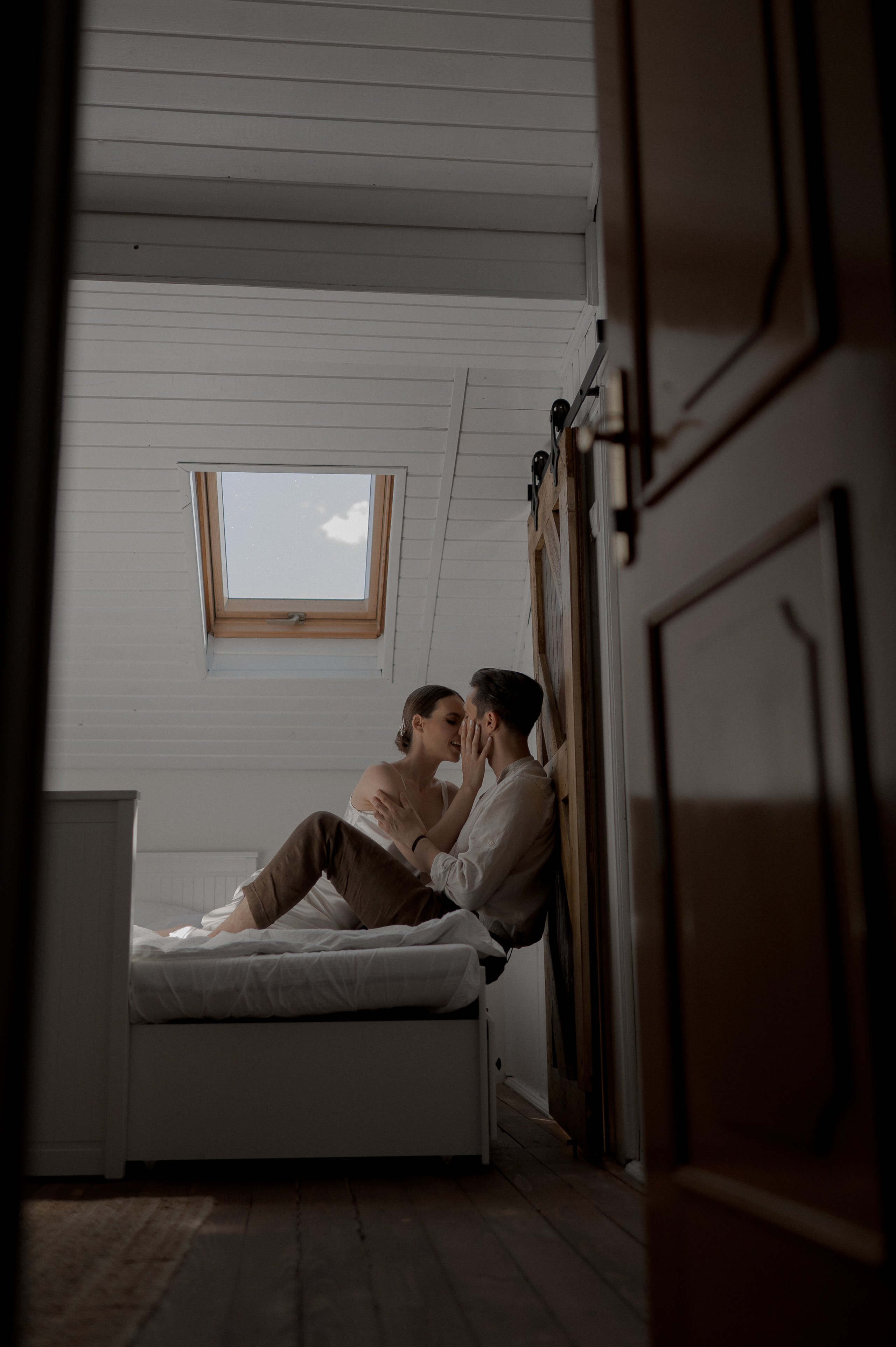 Intimate connection embraced by the couple in bed, symbolizing their deep love and anticipation for their special day.