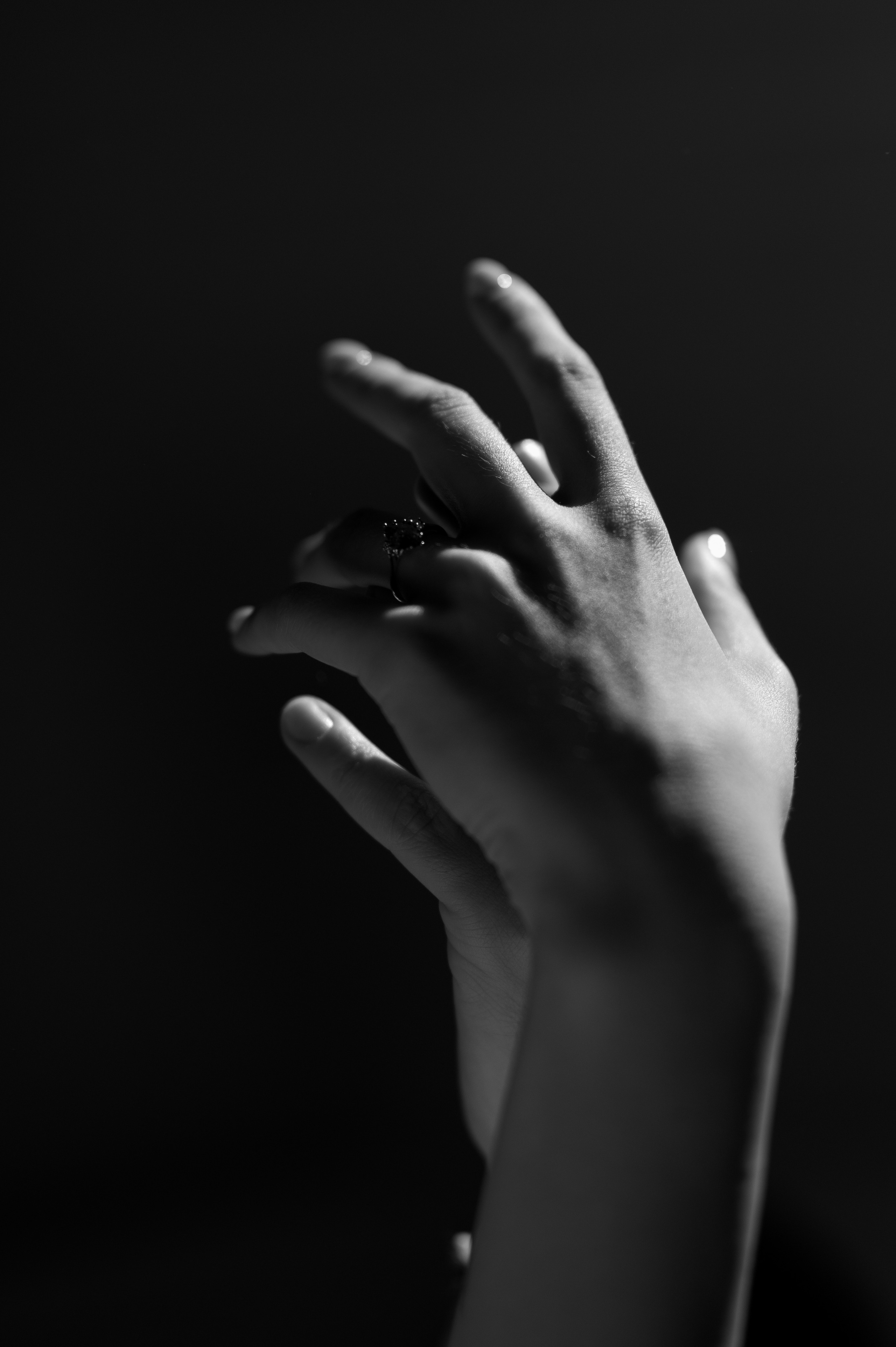 A delightful blend of laughter and affection is frozen in time as the couple kisses, their engagement ring stealing the spotlight with its one-of-a-kind stone, reflecting their distinctive love story.