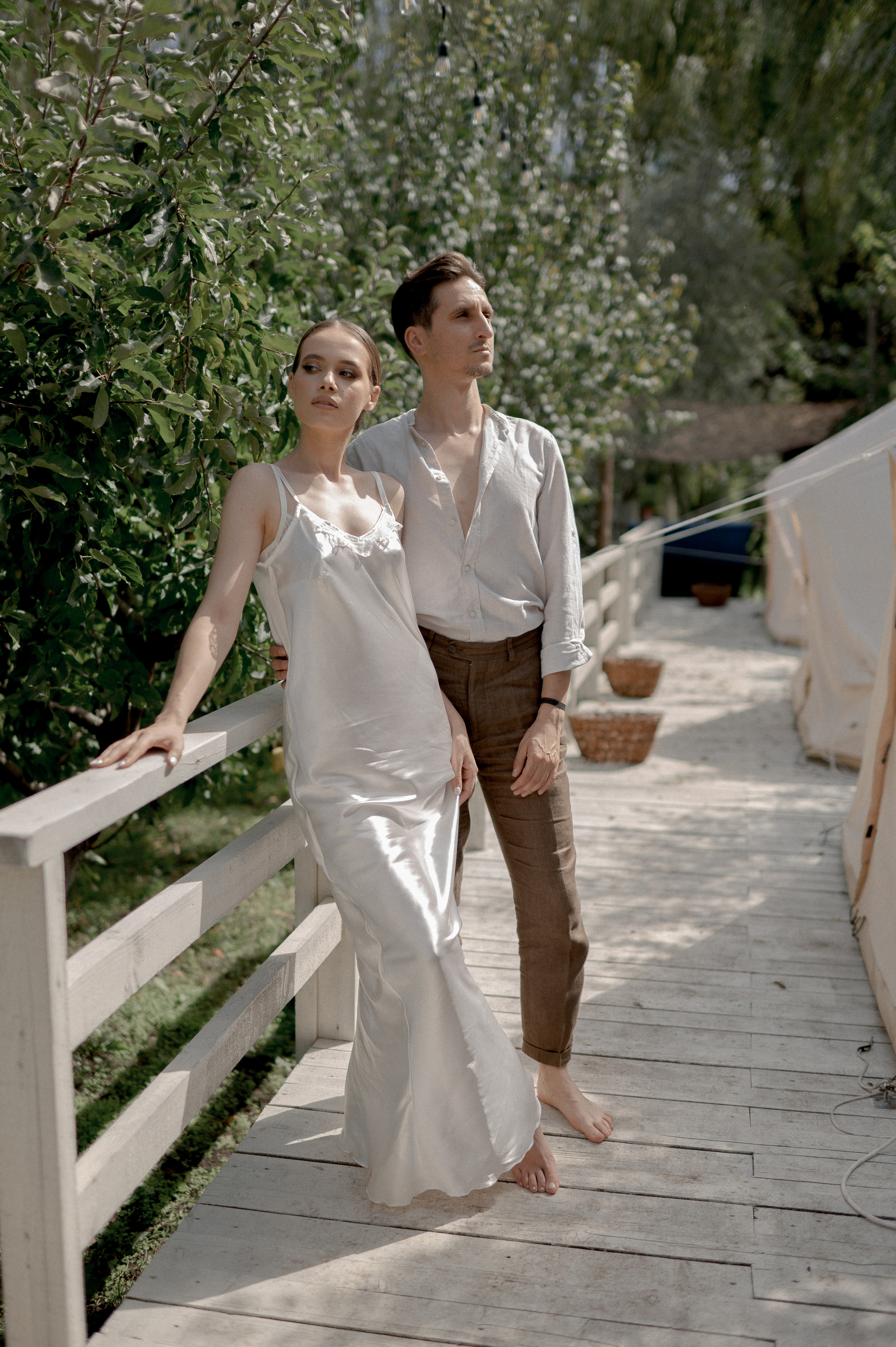 Surrounded by nature's beauty, the couple's wedding morning unfolds in a secluded garden, where glamping tents offer privacy and intimacy for their loving and tender connections.