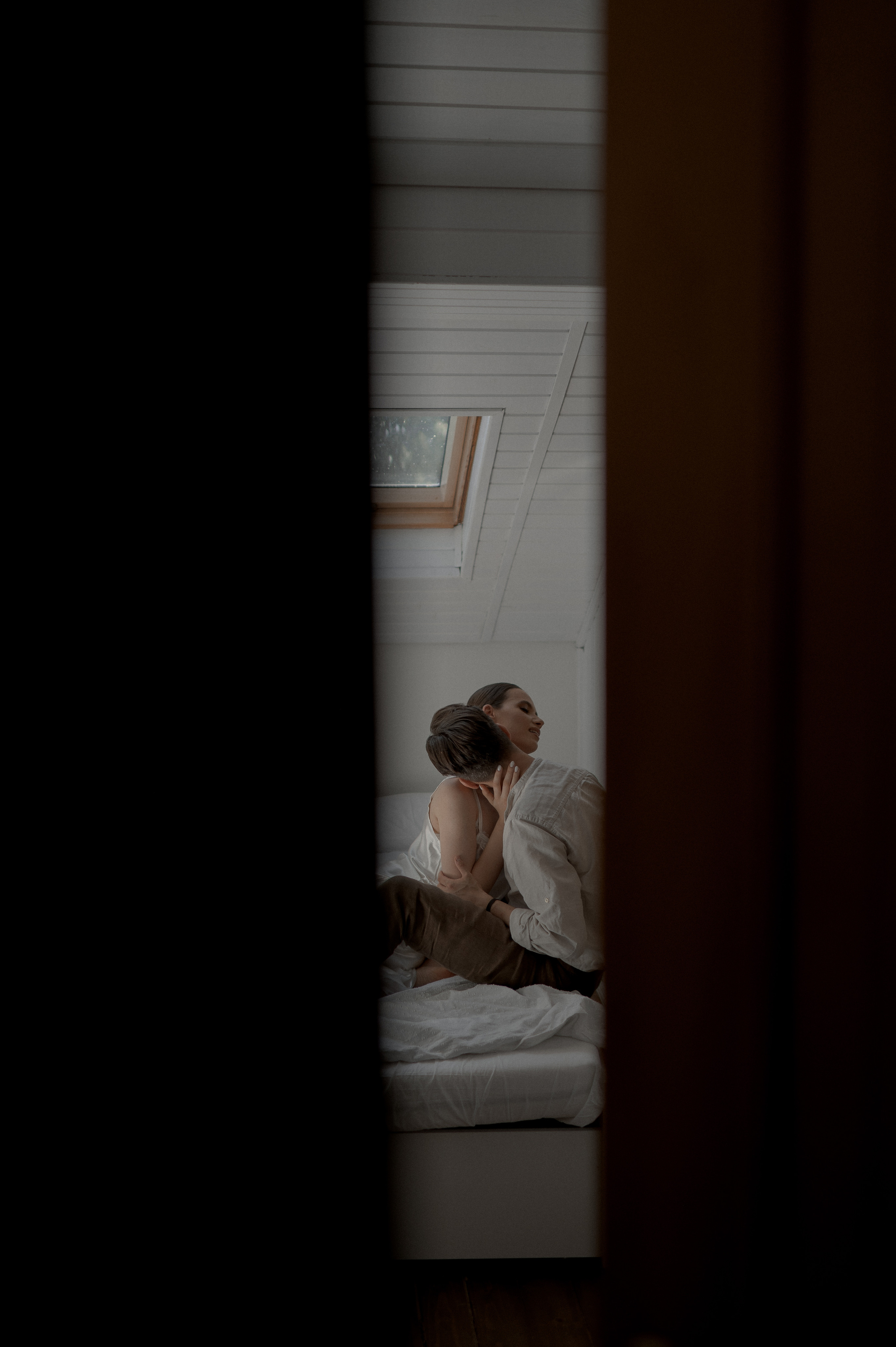 Tender morning bliss captured as the couple finds comfort in bed, reveling in love and anticipation for their wedding celebration.