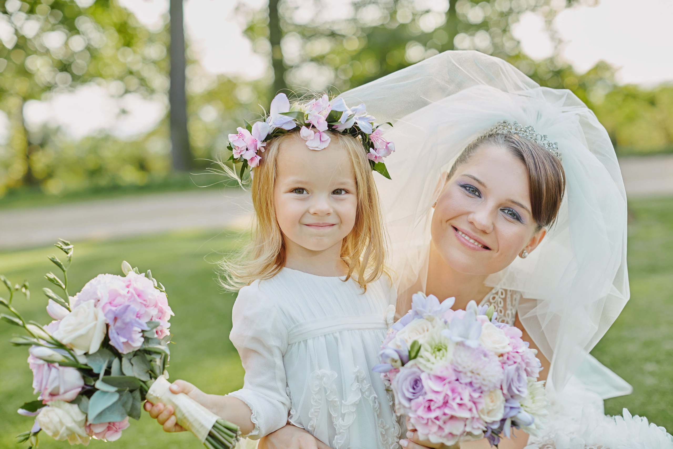 Bride and flower girl with bouquets at Chateau Mcely.