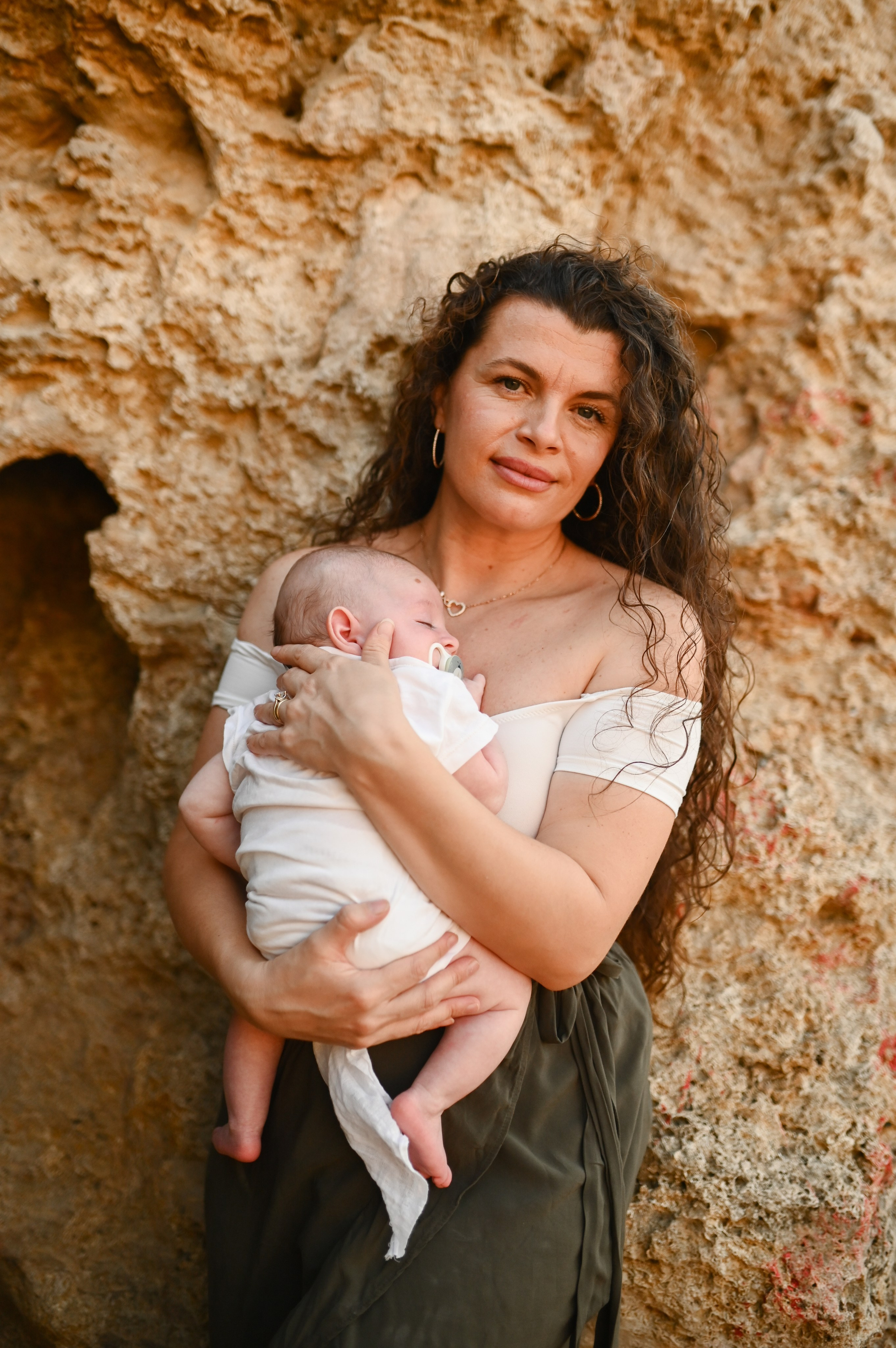 Happy family walking along a Rhodes beach at sunset. Photographer in Rhodes Island