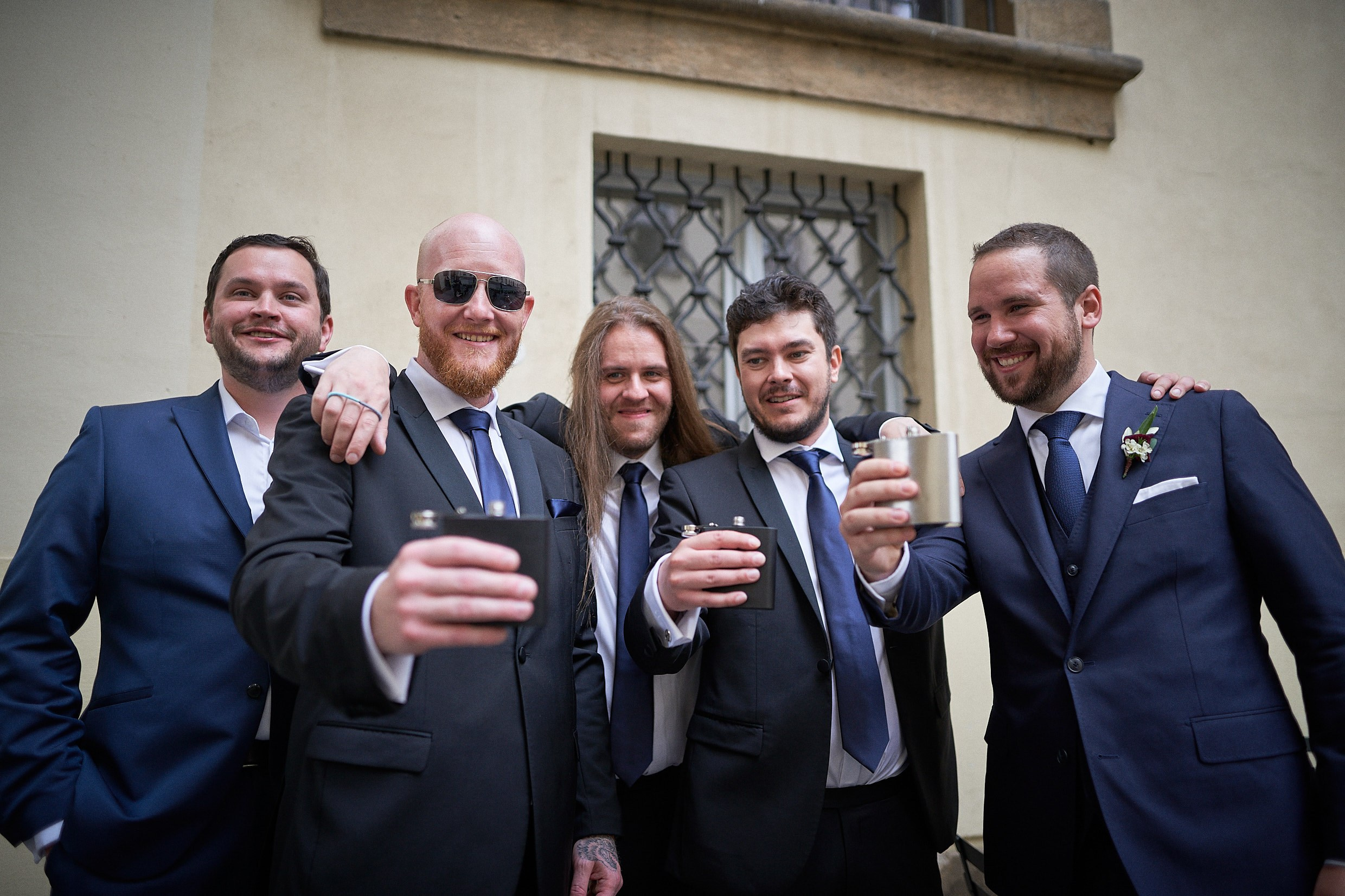 Groom Dean toasting whiskey with groomsmen before Mirror Chapel.