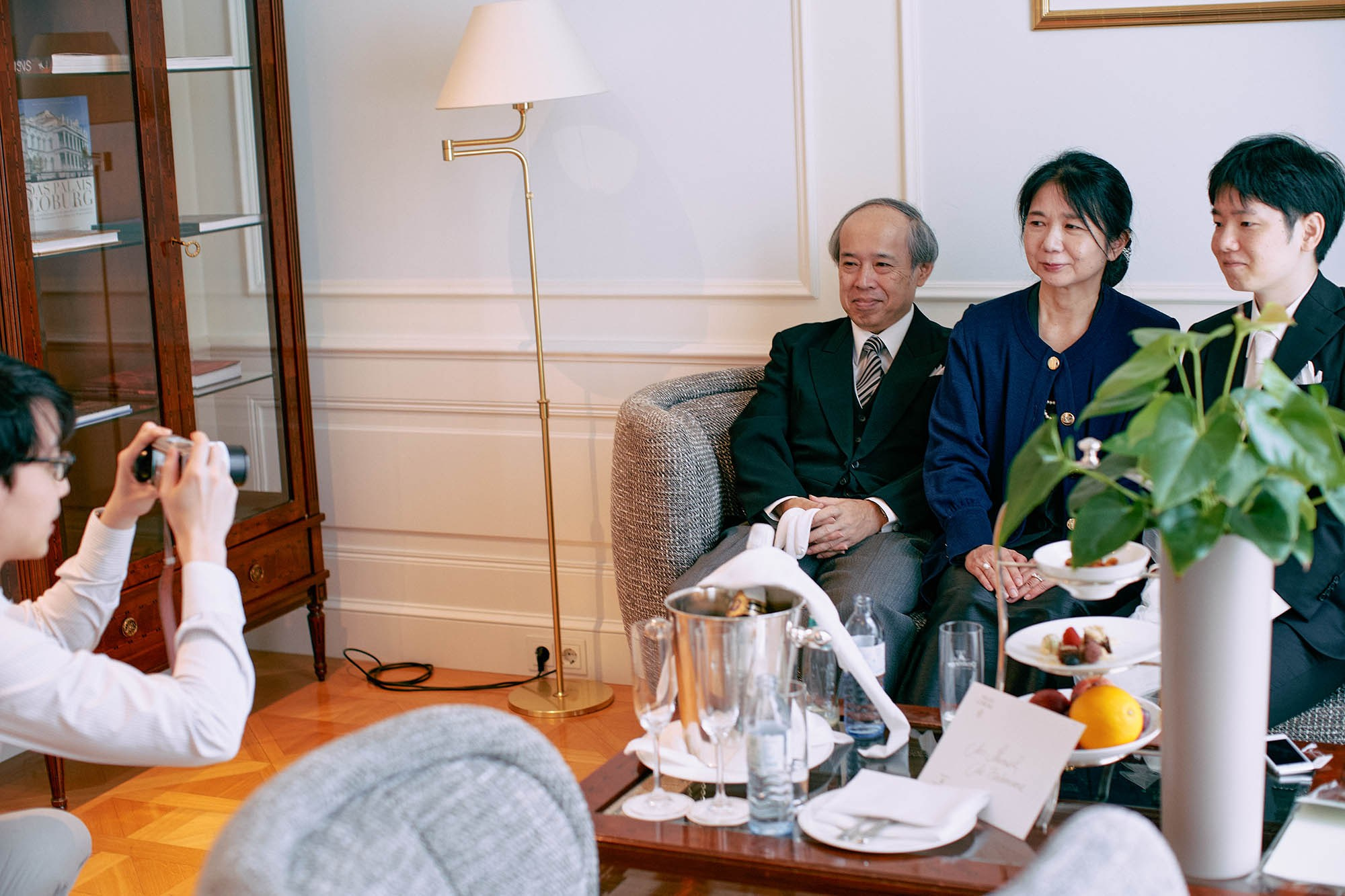 Katsuya takes a few family photos while they await.