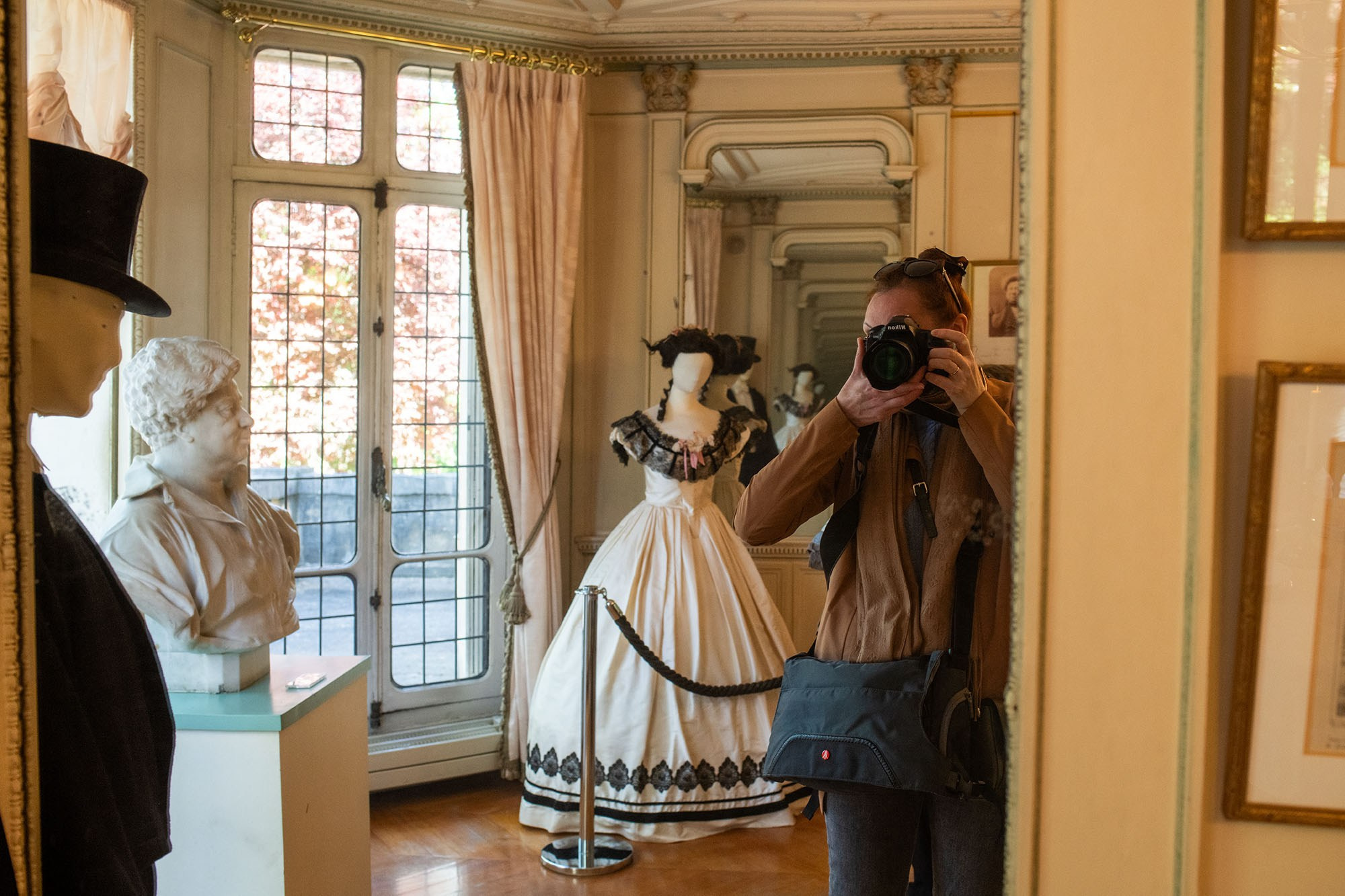 Mirror reflection of Château de Monte-Cristo interior with Alexandre Dumas bust and period costumes near Paris