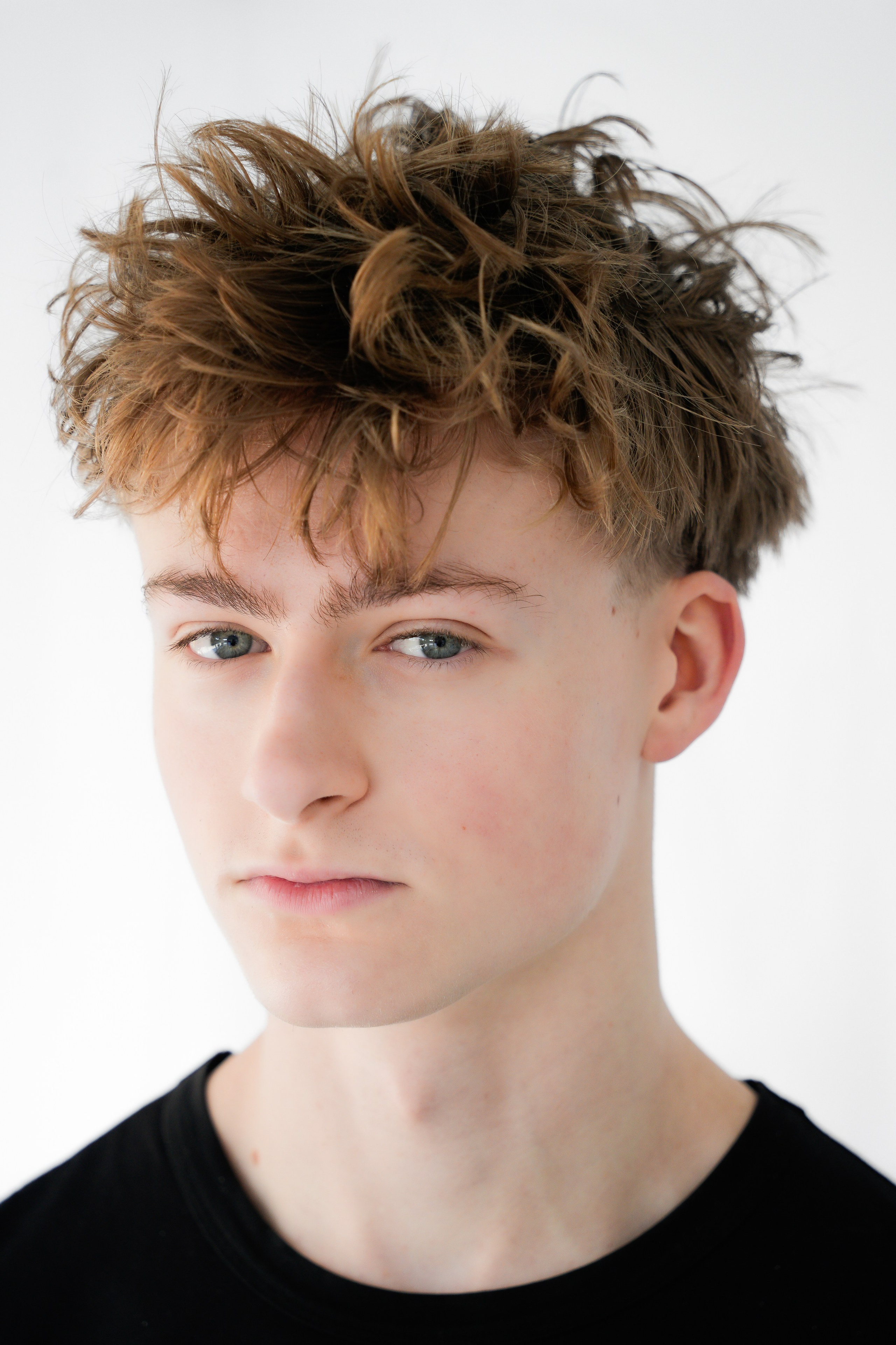 Clean studio headshot of a young actor with natural expression, photographed in soft light in Solihull.