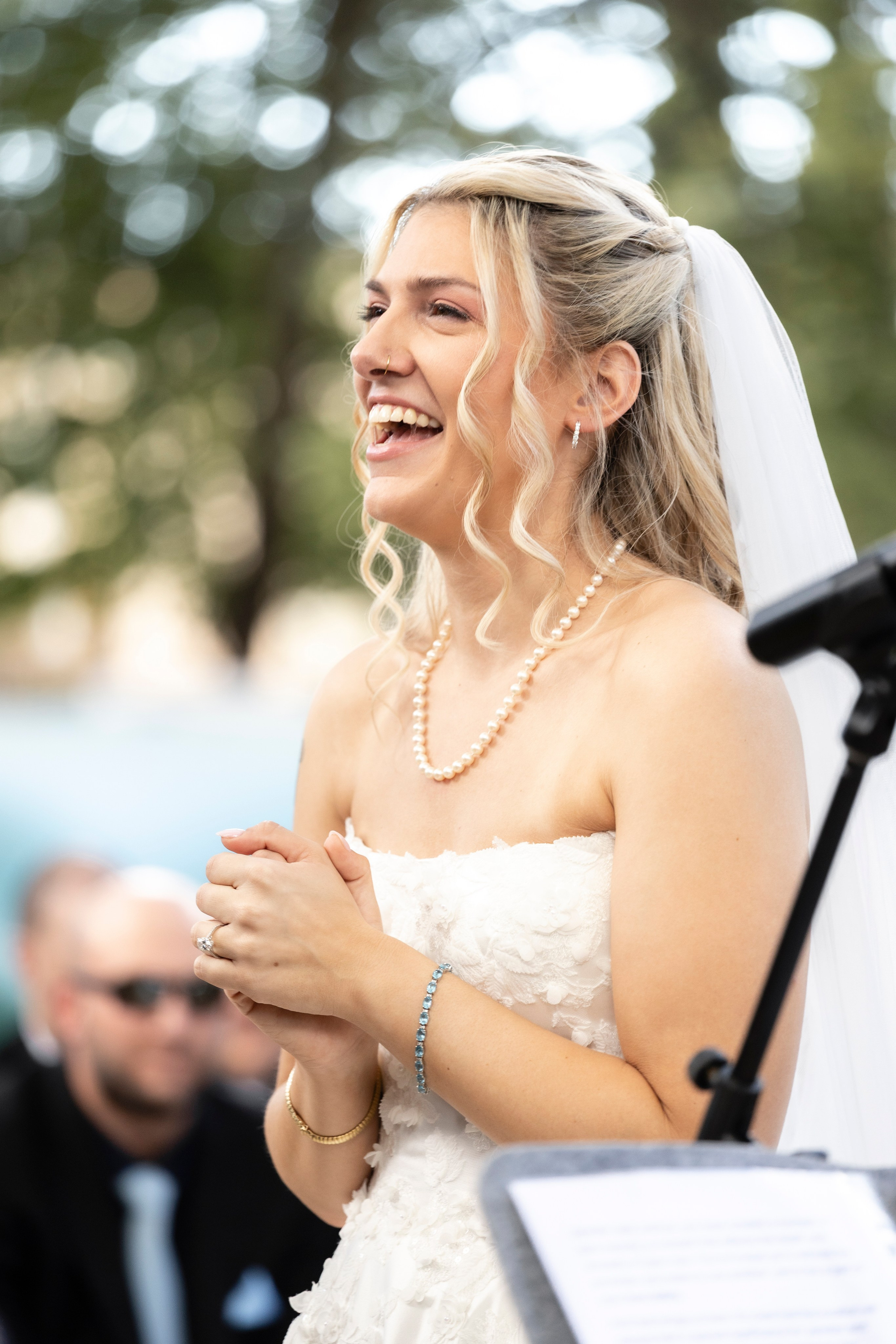 Mariée souriante et émue pendant la cérémonie en extérieur au Château Rieutort, mariage d’automne dans le Sud de la France