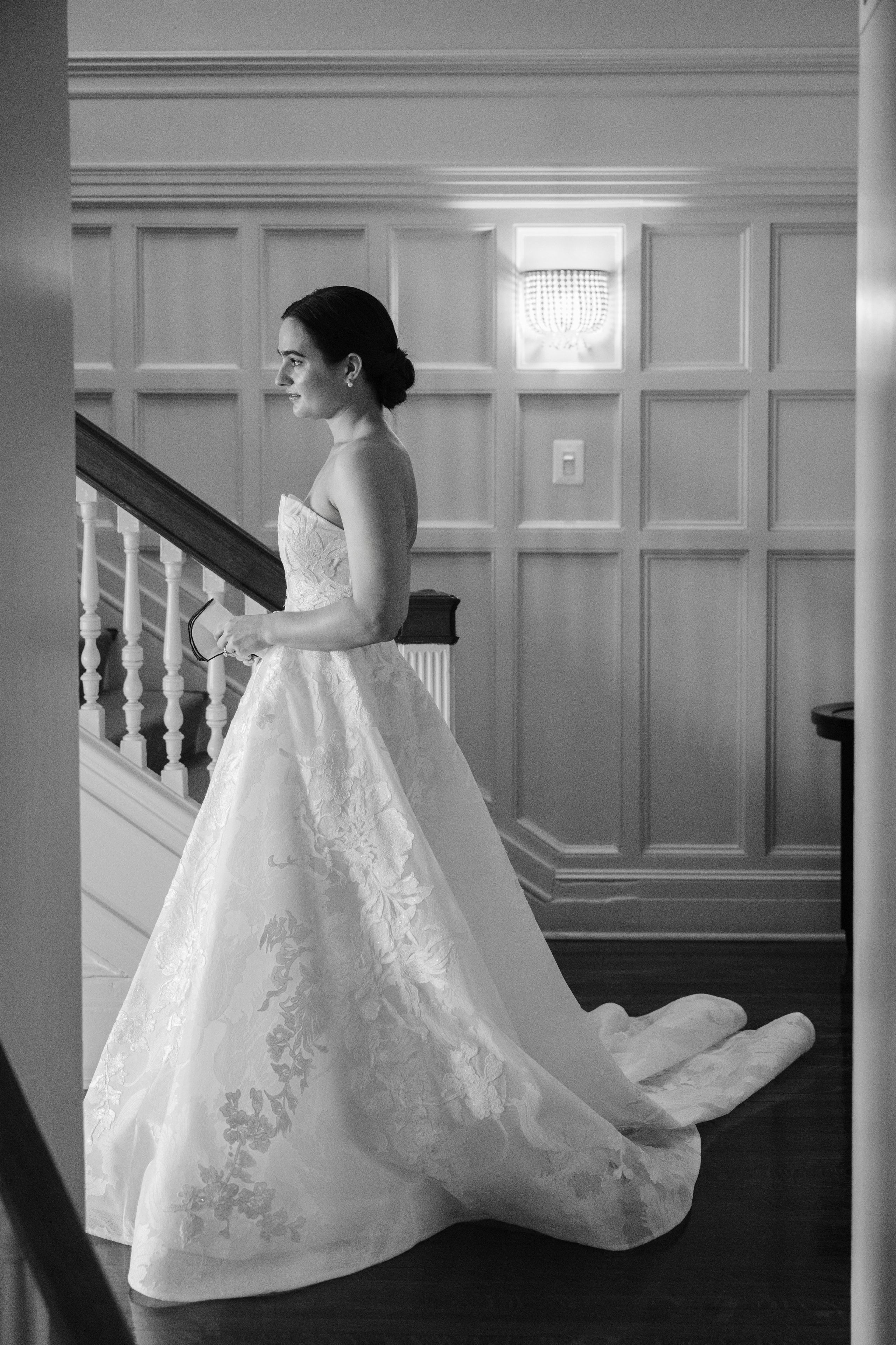 a bride in a wedding dress standing on the stairs