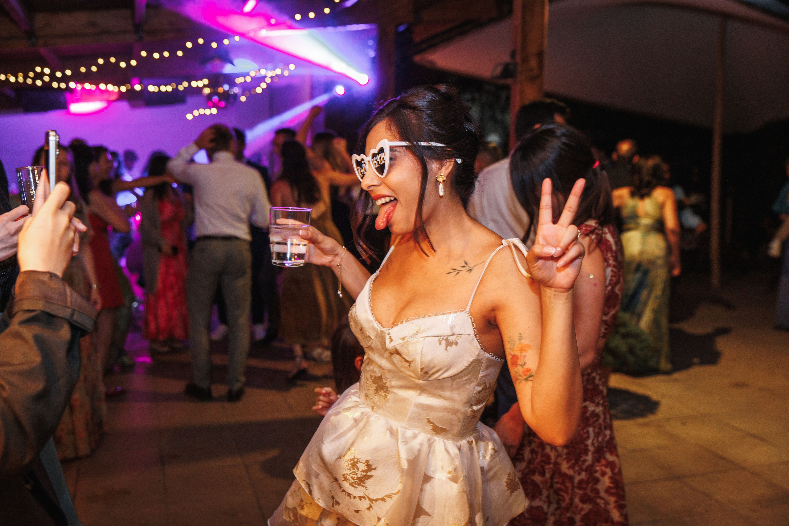 Nride enjoys the wedding dance party and has a joyful time with guests.
