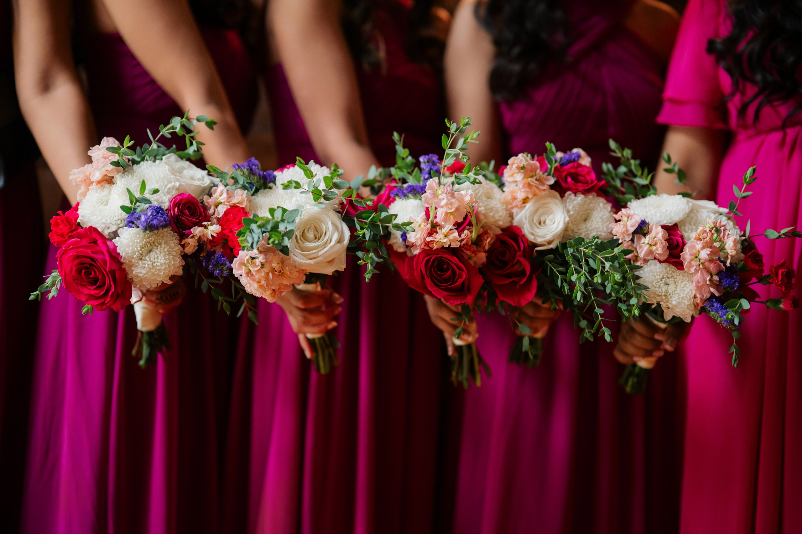 a bridesmaid holding their bouquets in their hands