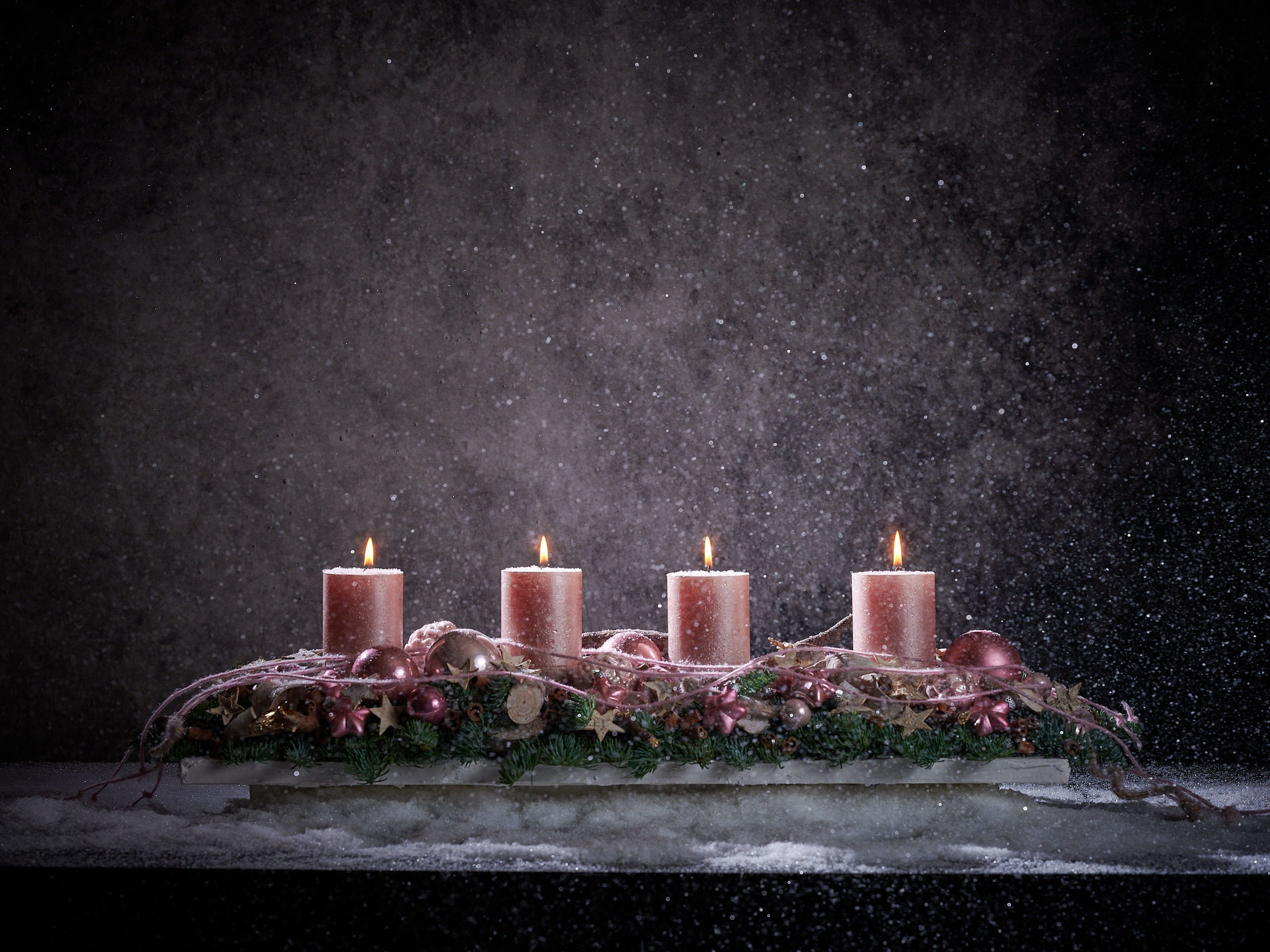 Blumenfotografie Wien – Advent-Kerzenarrangement mit fünf rosafarbenen Stumpenkerzen.