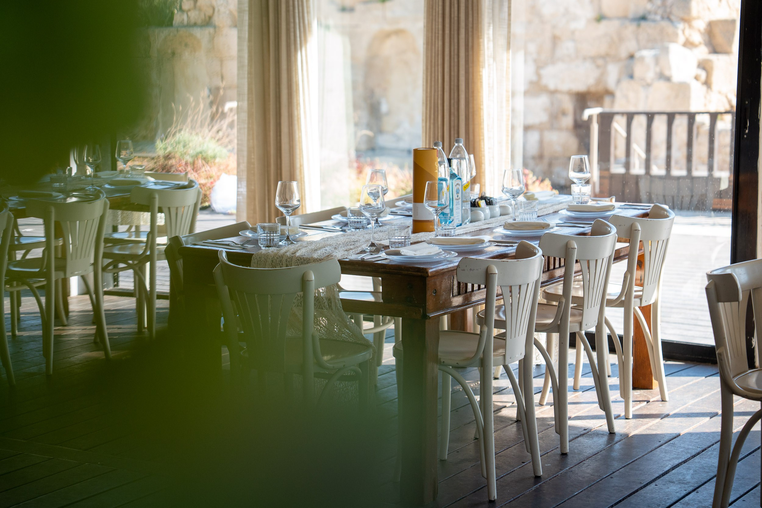 A reception table set beside large windows at Aresto