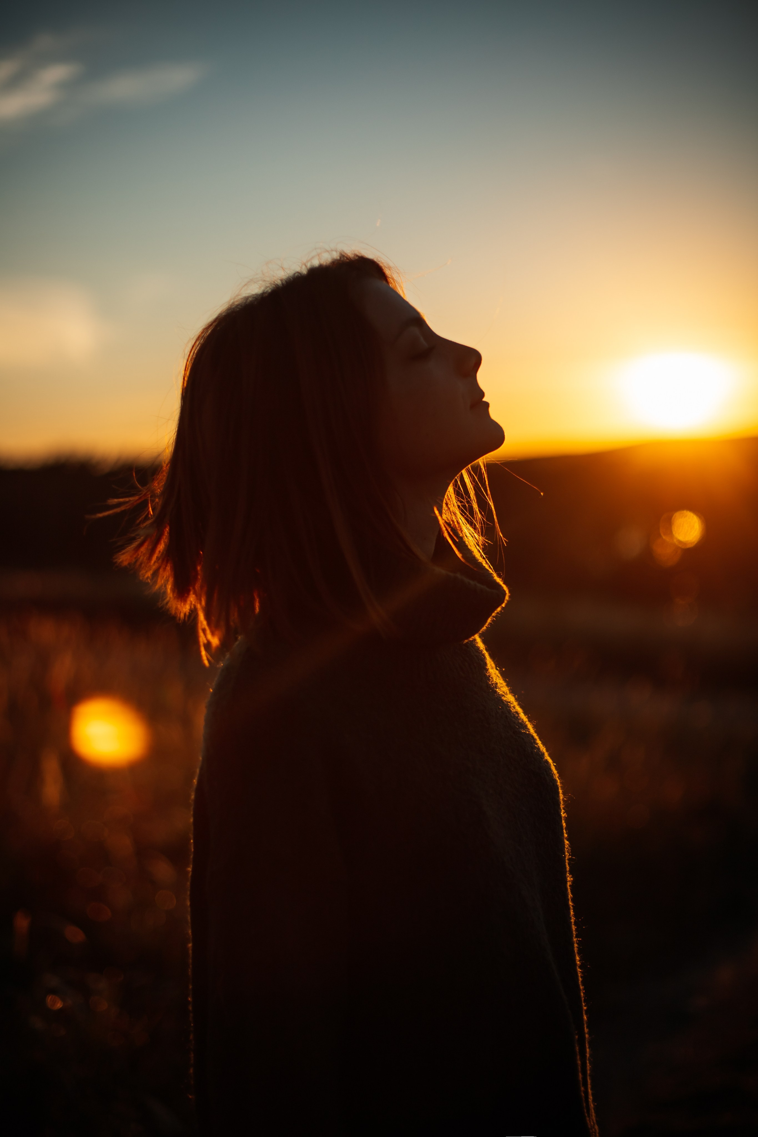 Woman’s portrait at sunset with warm golden light
