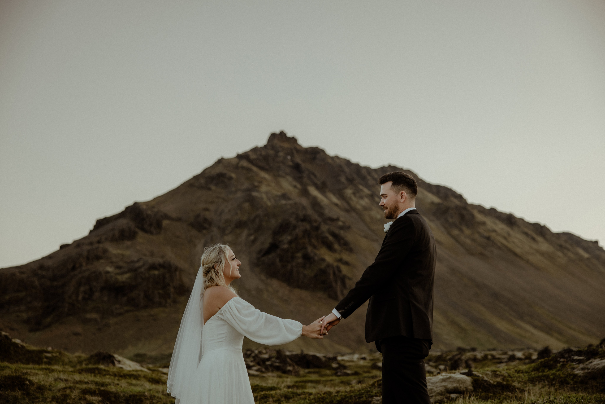 Iceland elopement at Budir with midnight sun wedding photos at black sand beach. Iceland elopement photographer & videographer