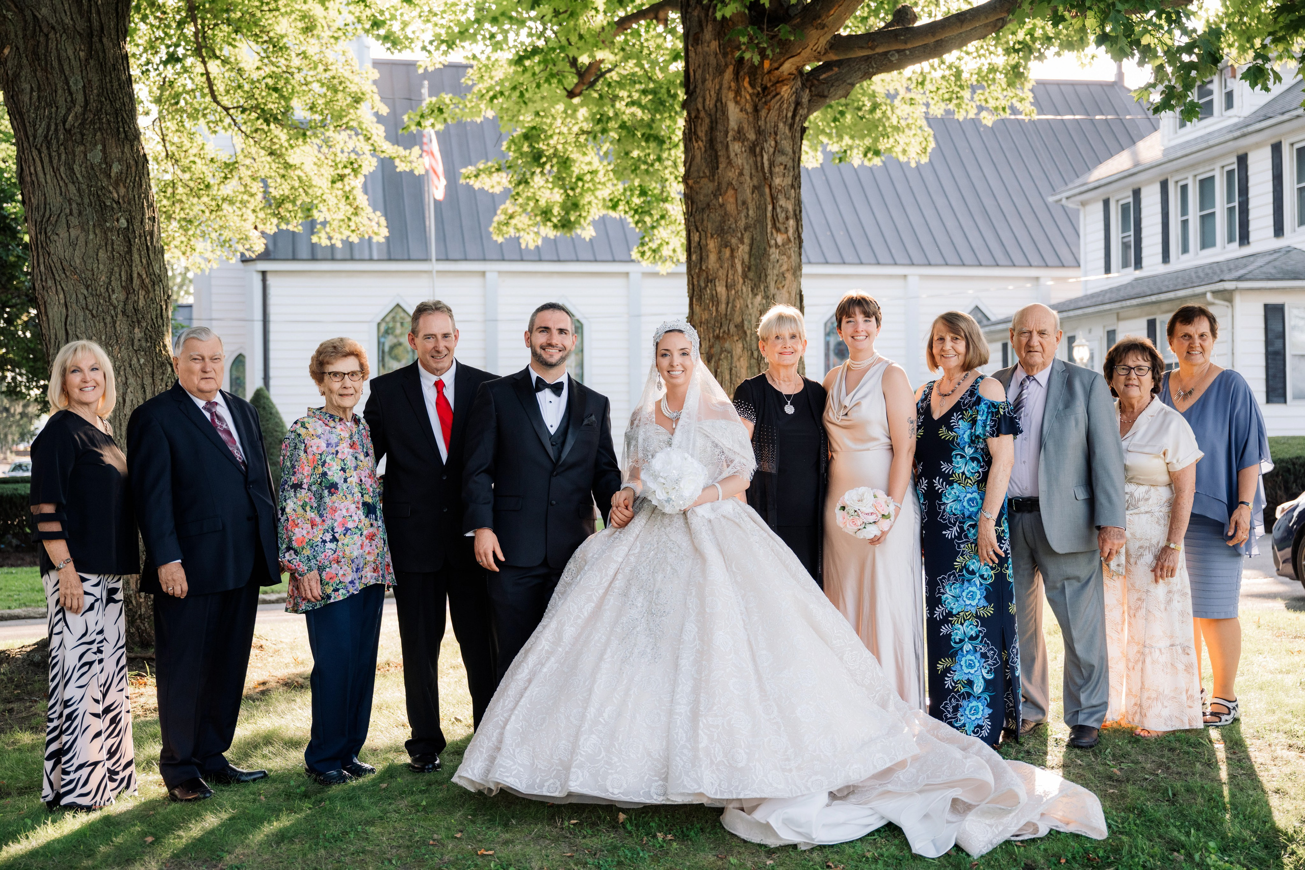 a group of people standing in front of a house