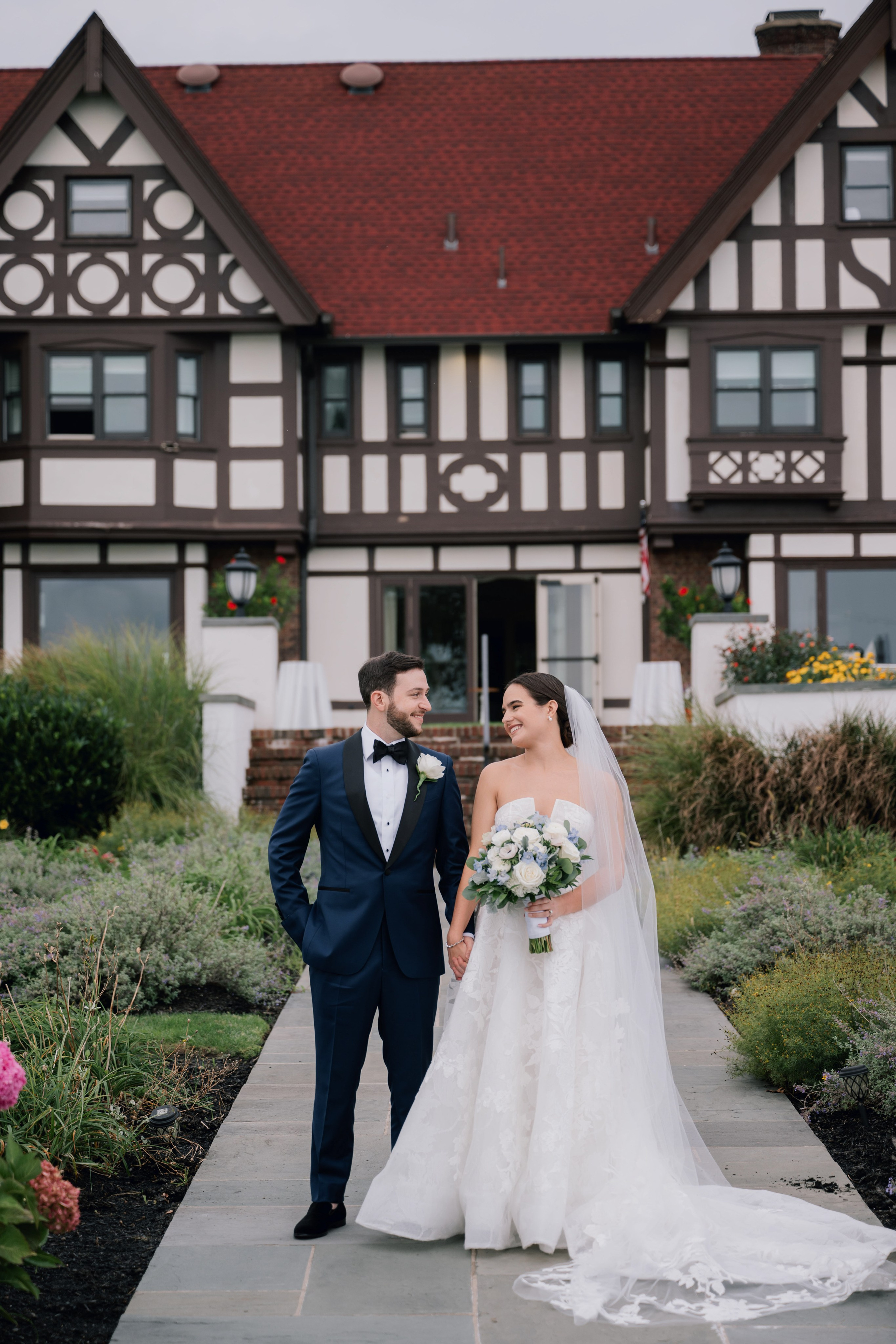 a bride and groom walking down the path to their wedding ceremony
