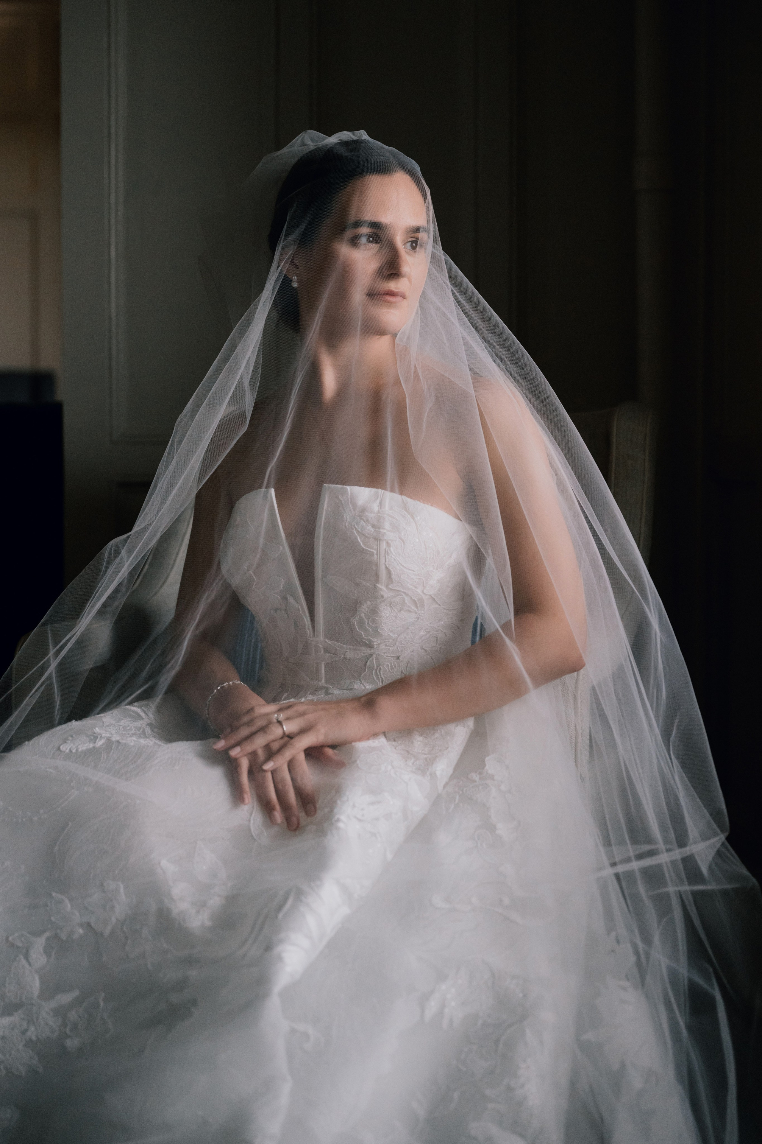 a woman in a wedding dress sitting on a couch