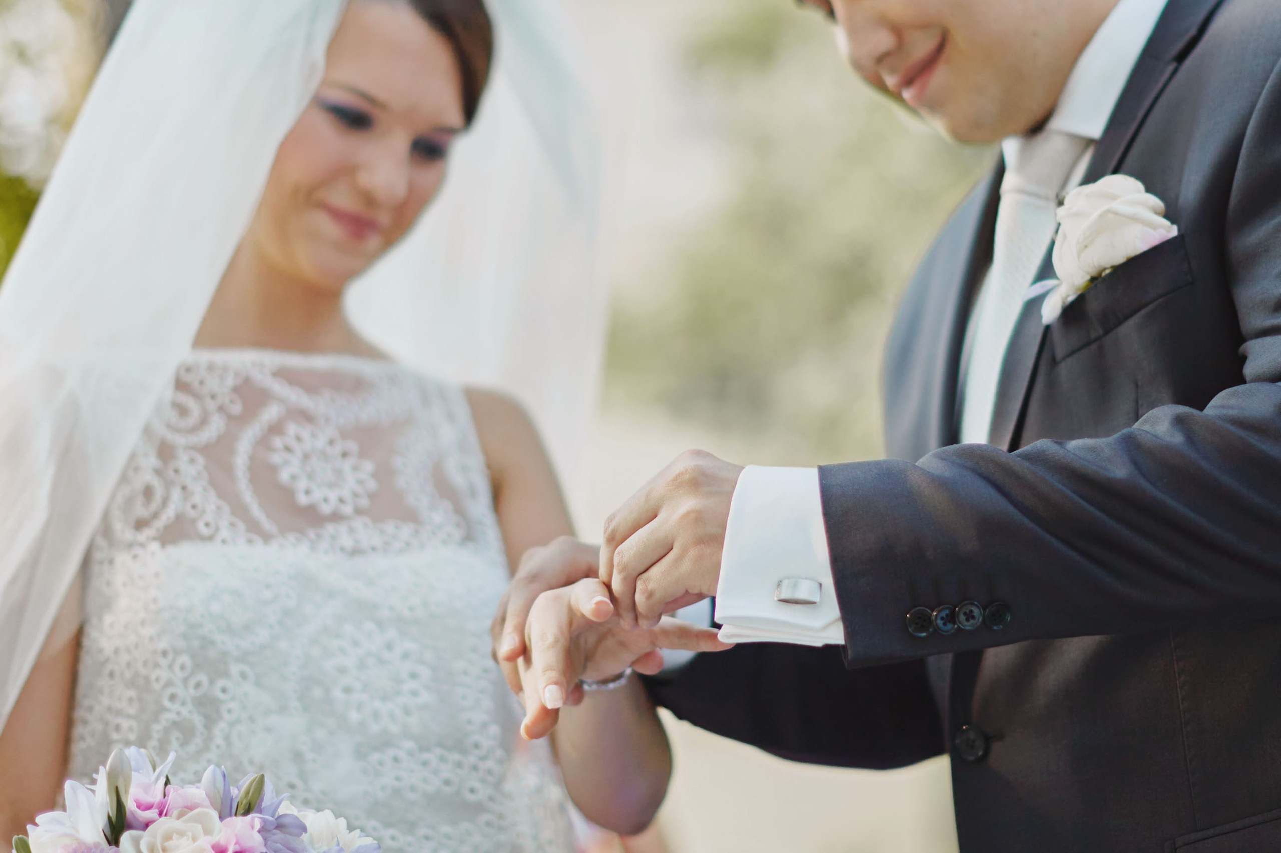 Romantic ring exchange at outdoor Czech chateau wedding.