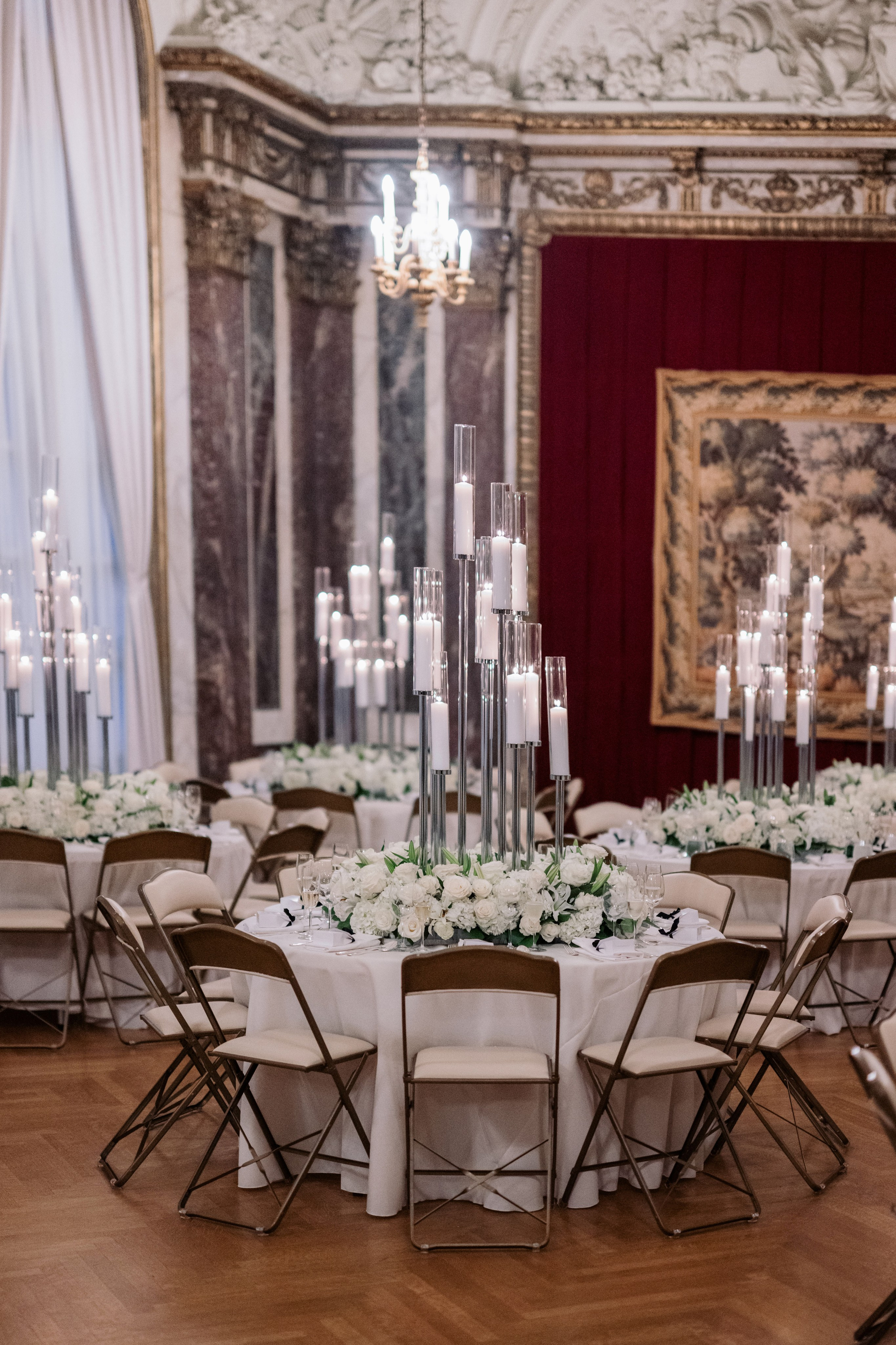 a room with tables and chairs with candles