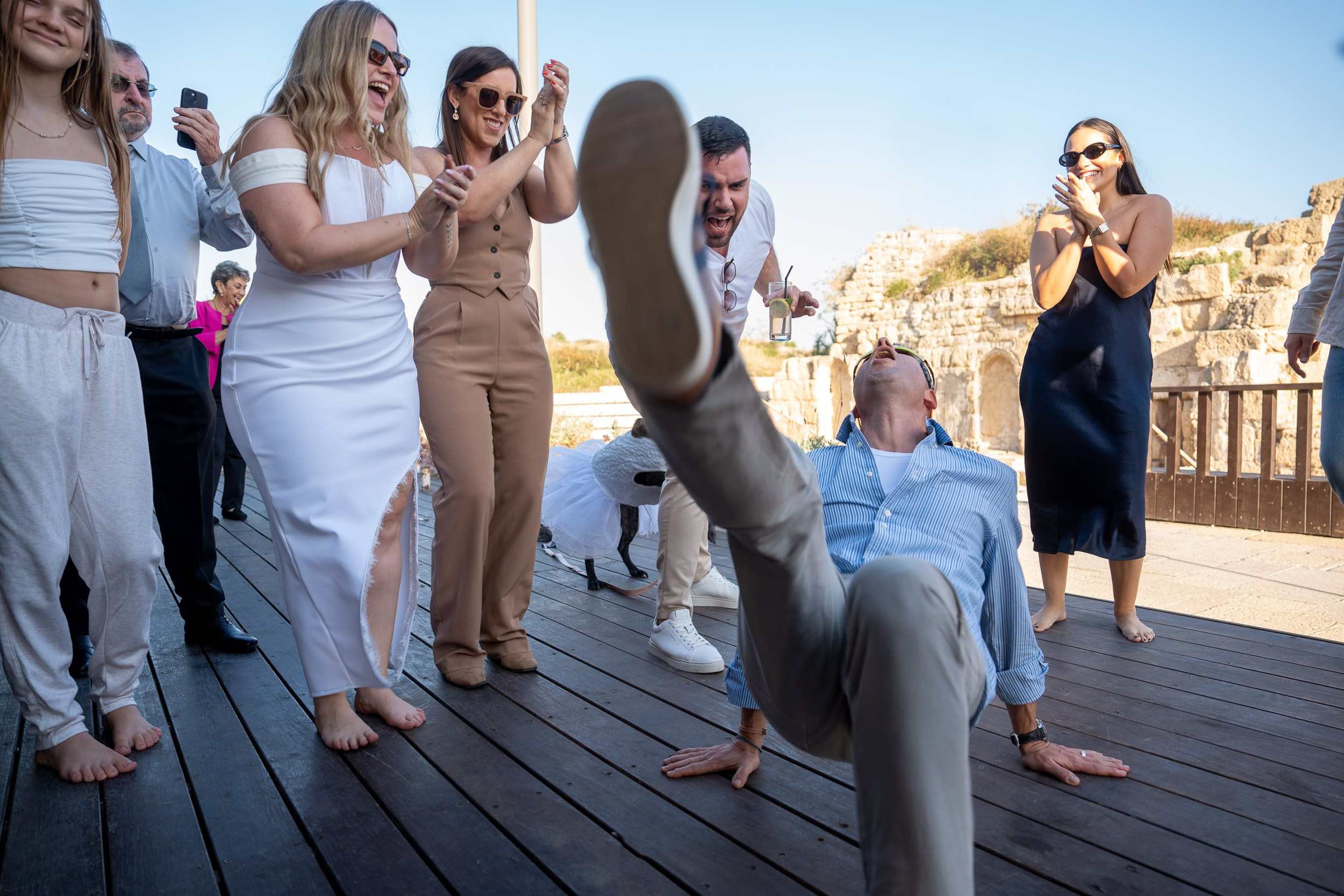 A wedding guest breakdances on the outdoor dance floor