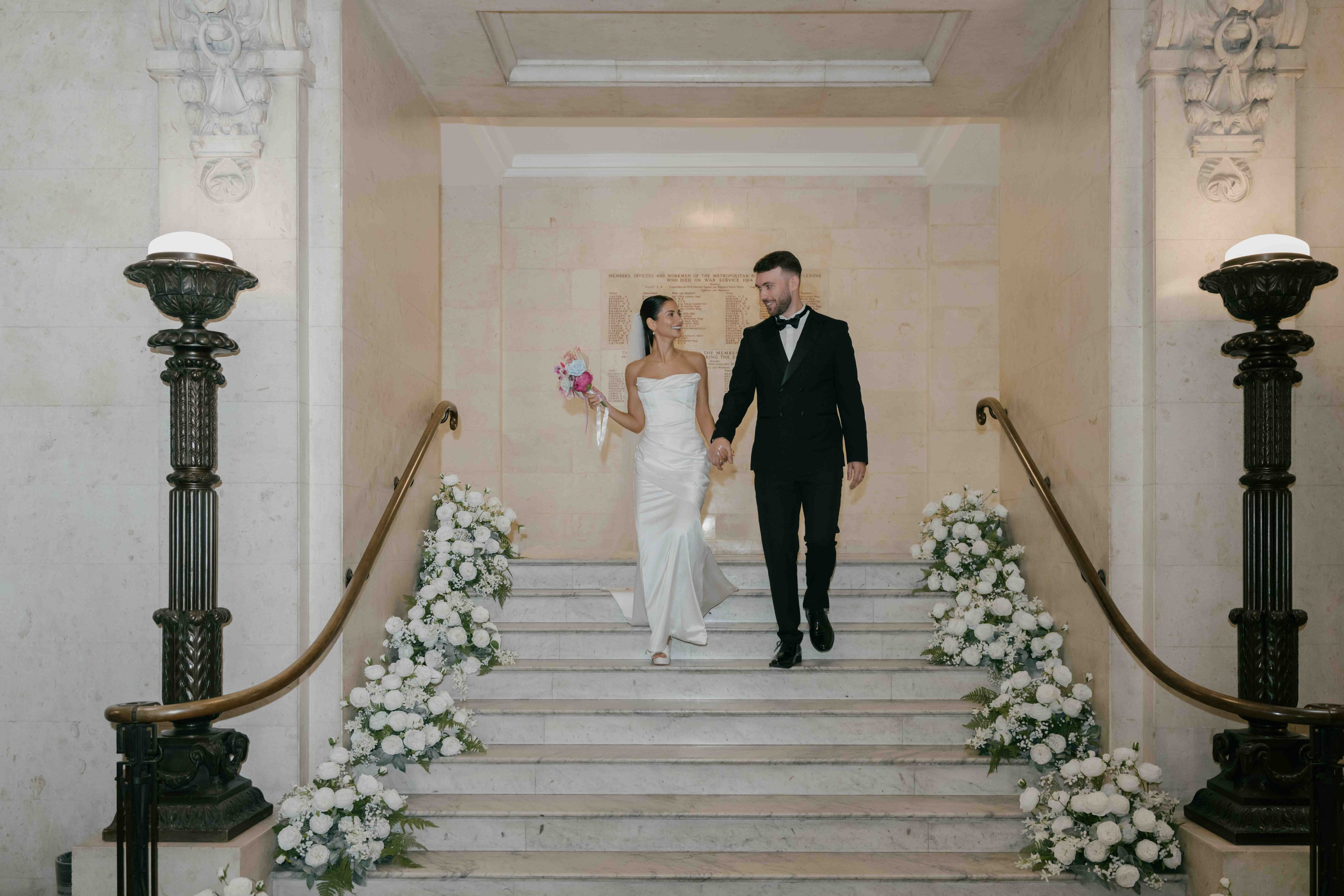 Marylebone Town Hall wedding London bride and groom walking stairs intimate wedding photographer London candid moment