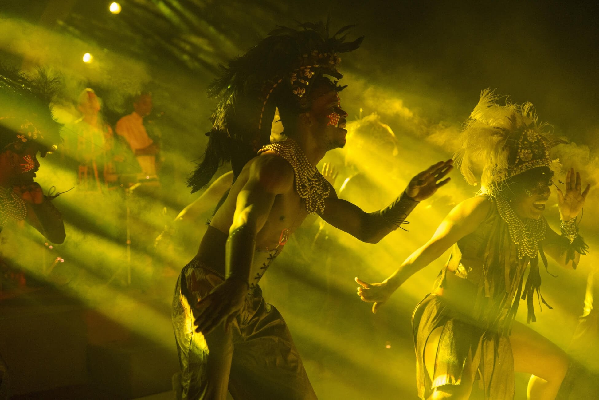 Performers dancing during luxury desert wedding reception with stage lighting