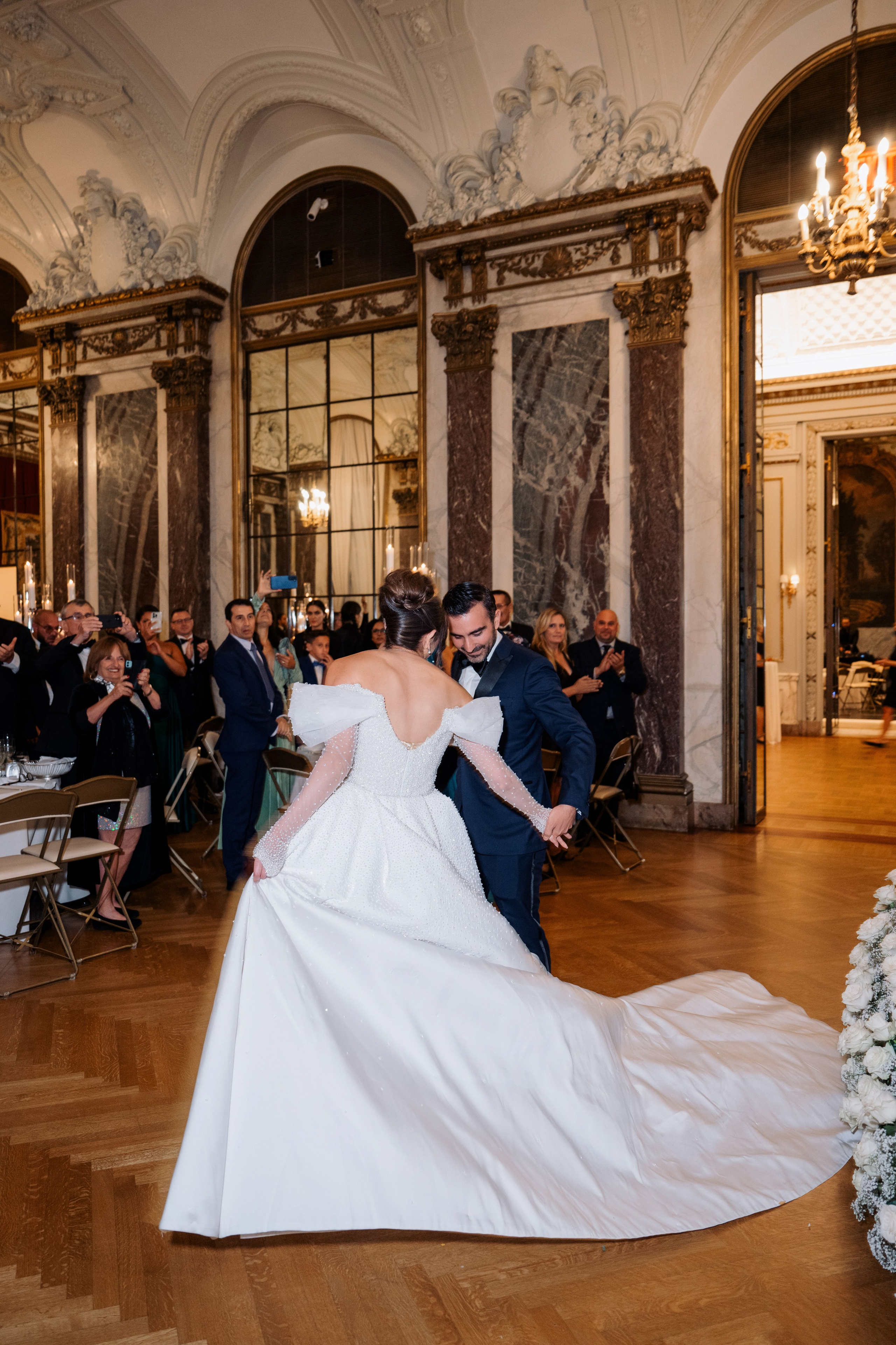 a bride and groom dancing in a ballroom