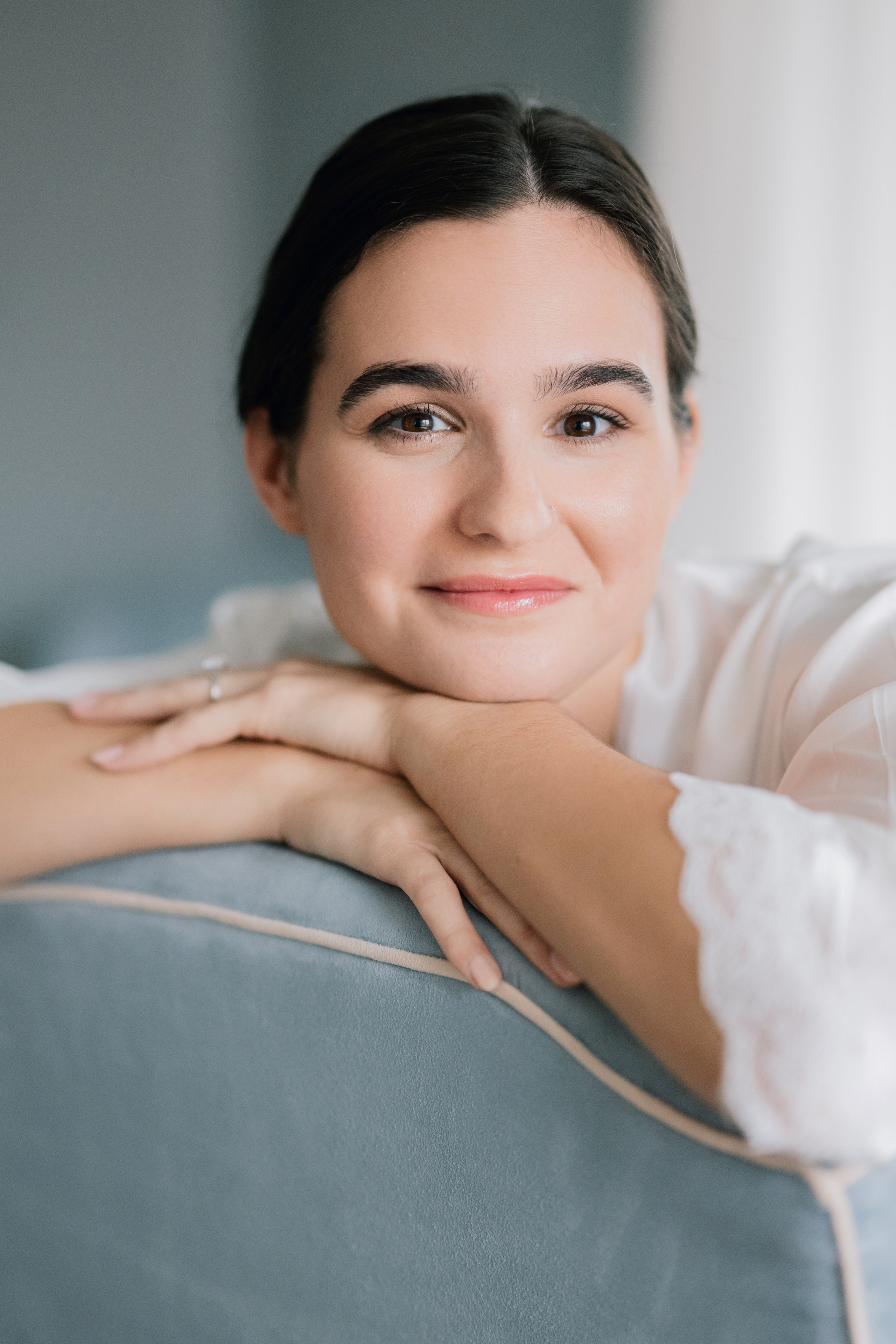a woman sitting on a couch with her arms crossed