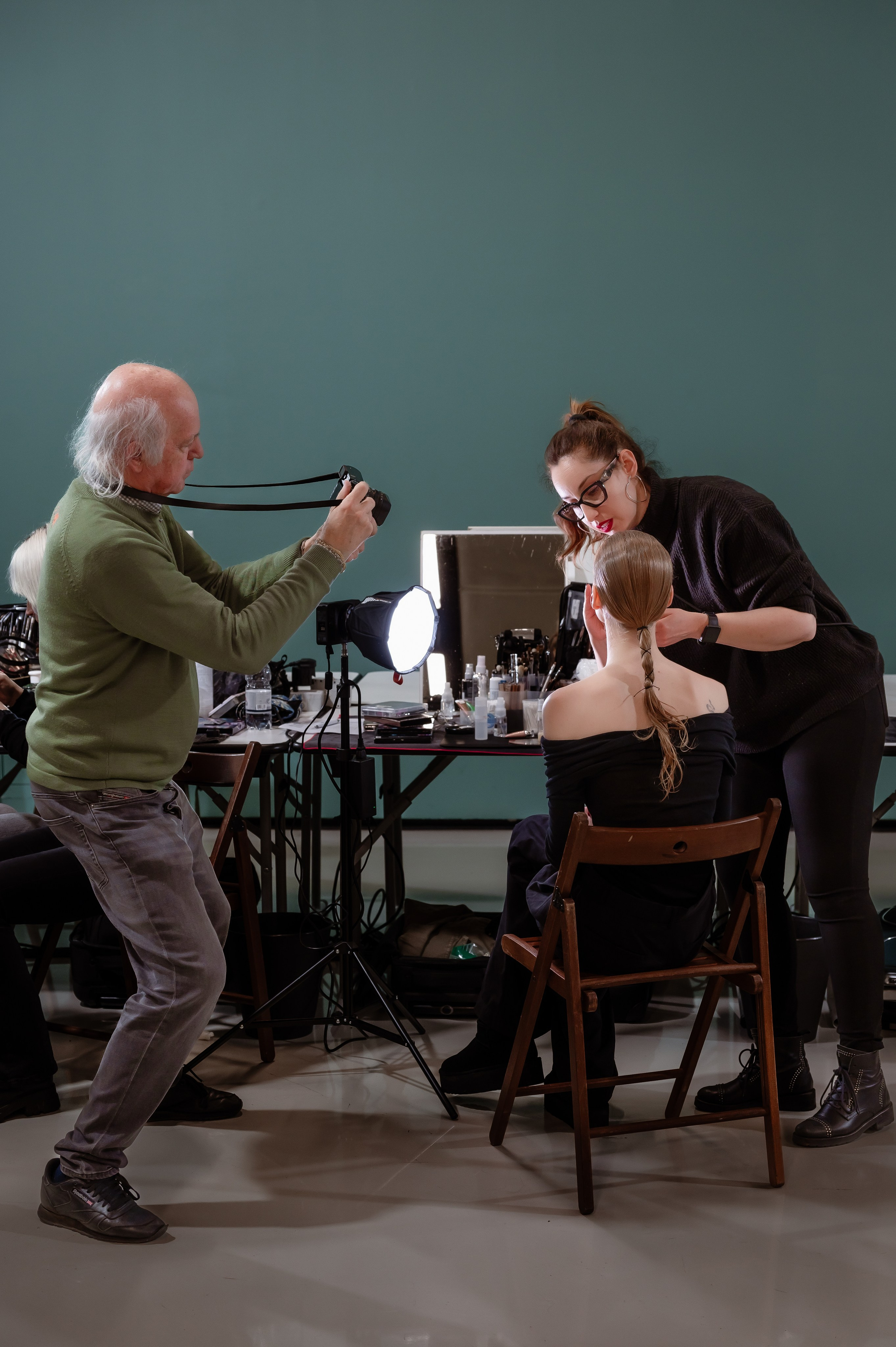 Candid backstage portrait of model in makeup chair