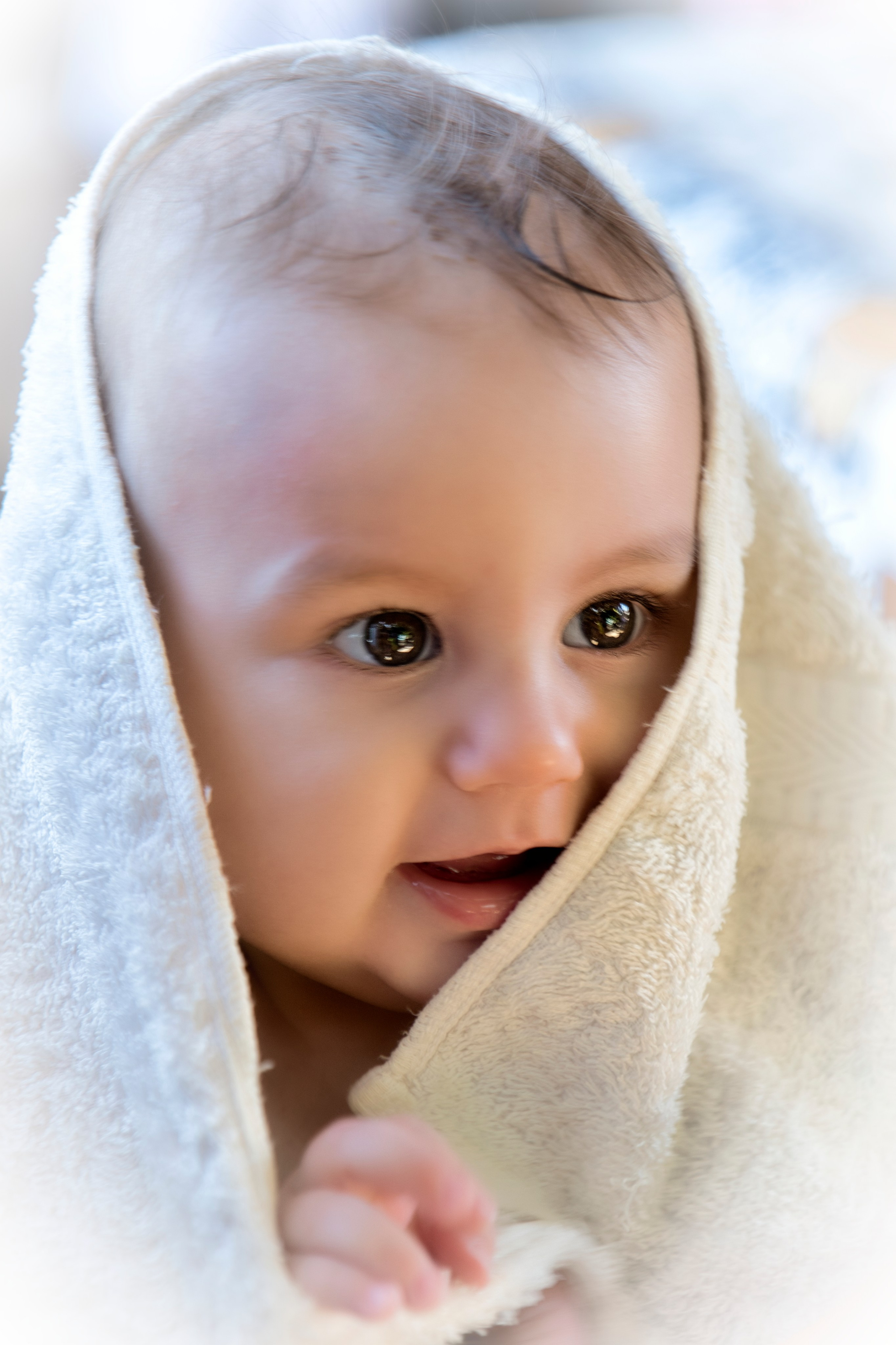 Bebé envuelto en una toalla blanca después del baño.
