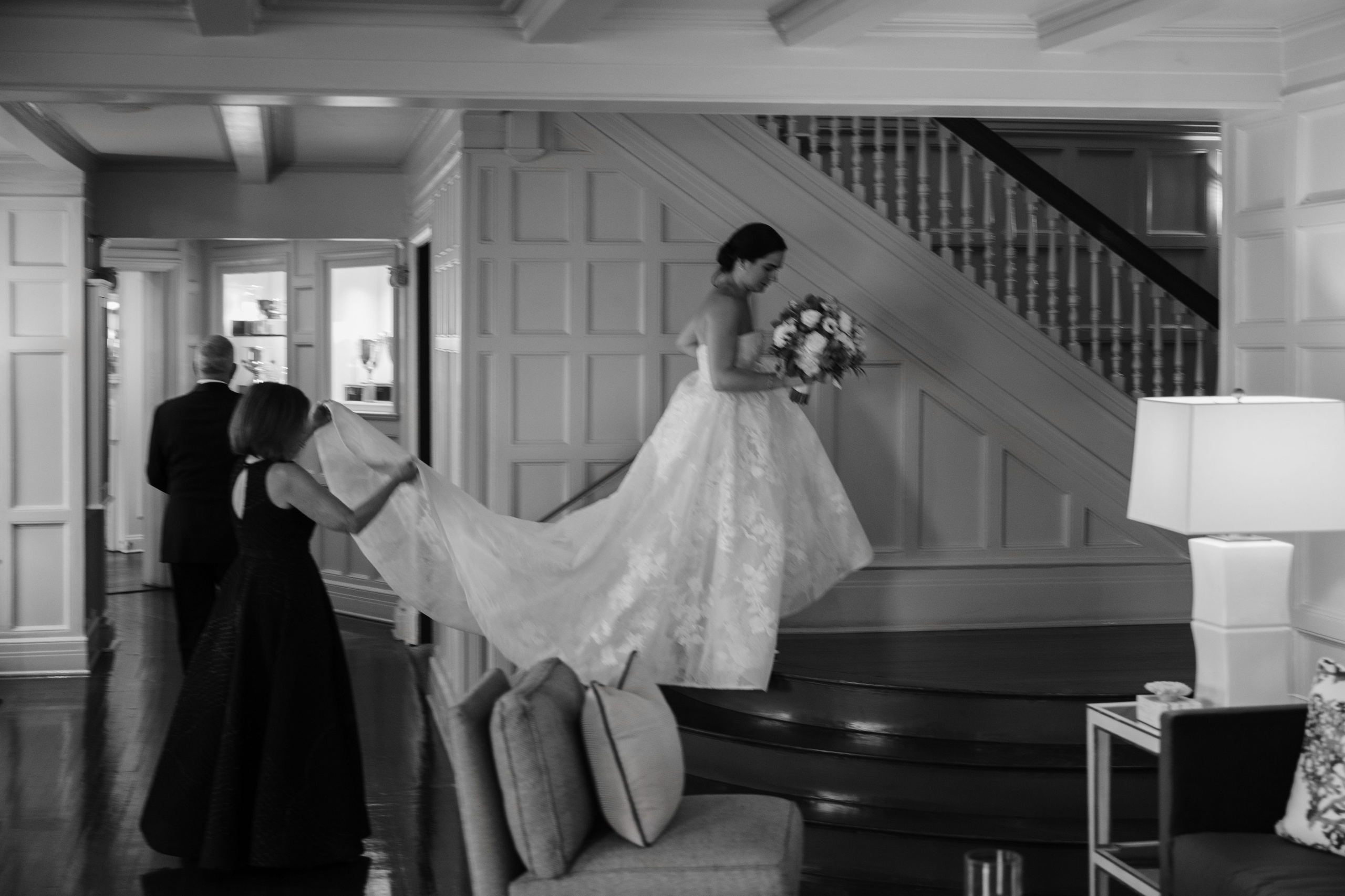 a bride is getting ready to get into her wedding dress