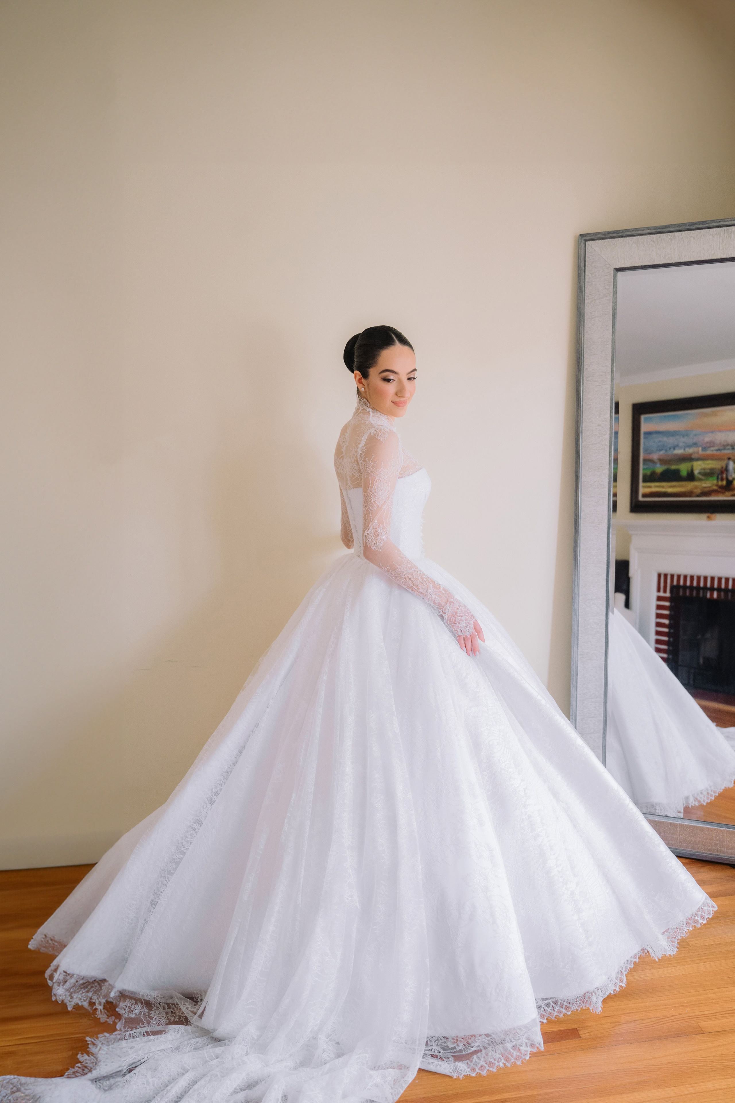 a woman in a wedding dress standing in front of a mirror