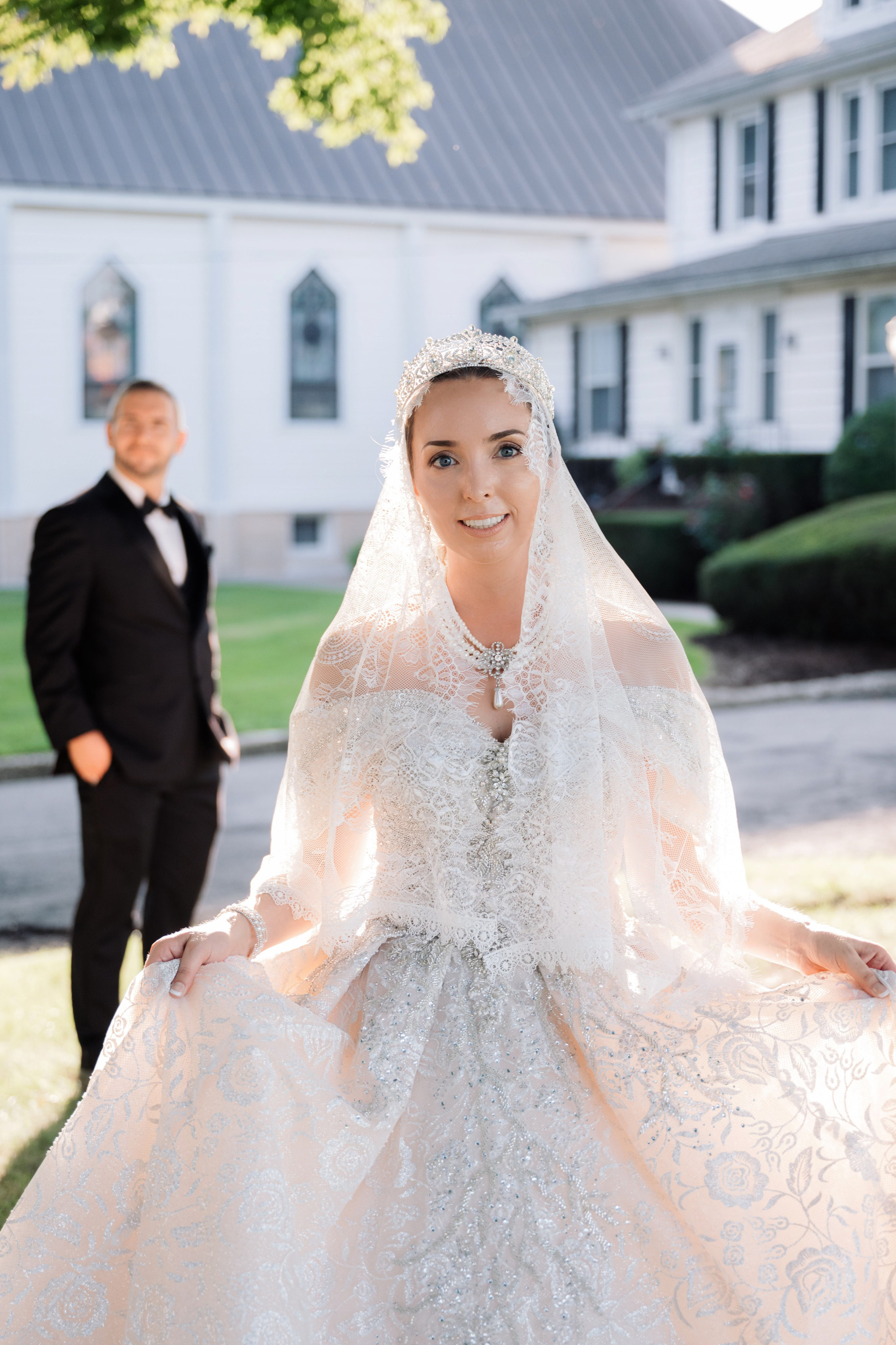 a bride and groom walking in front of a white house