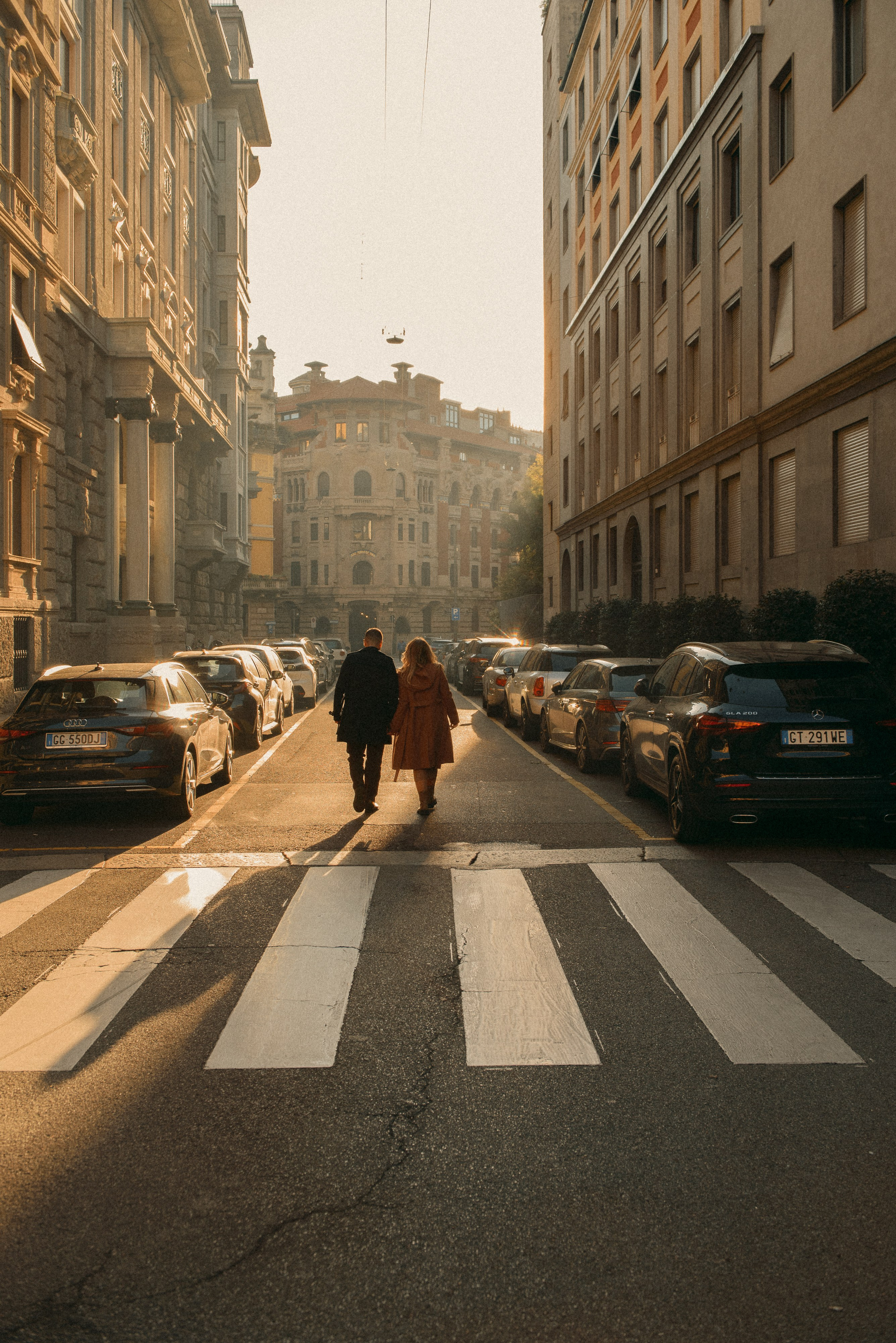 Italy engagement photos of a couple walking through charming Milan streets.