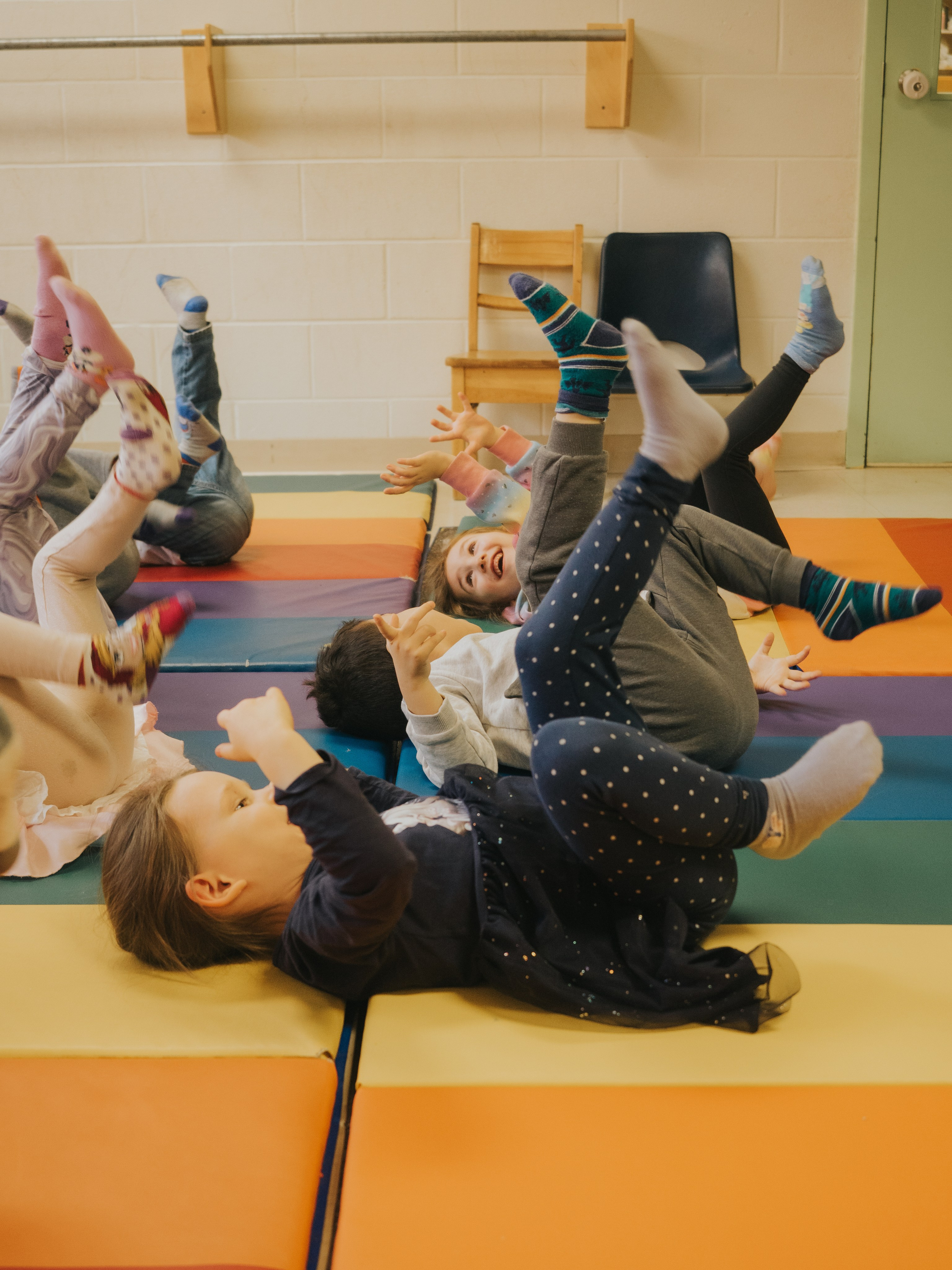 Children with their legs in the air.