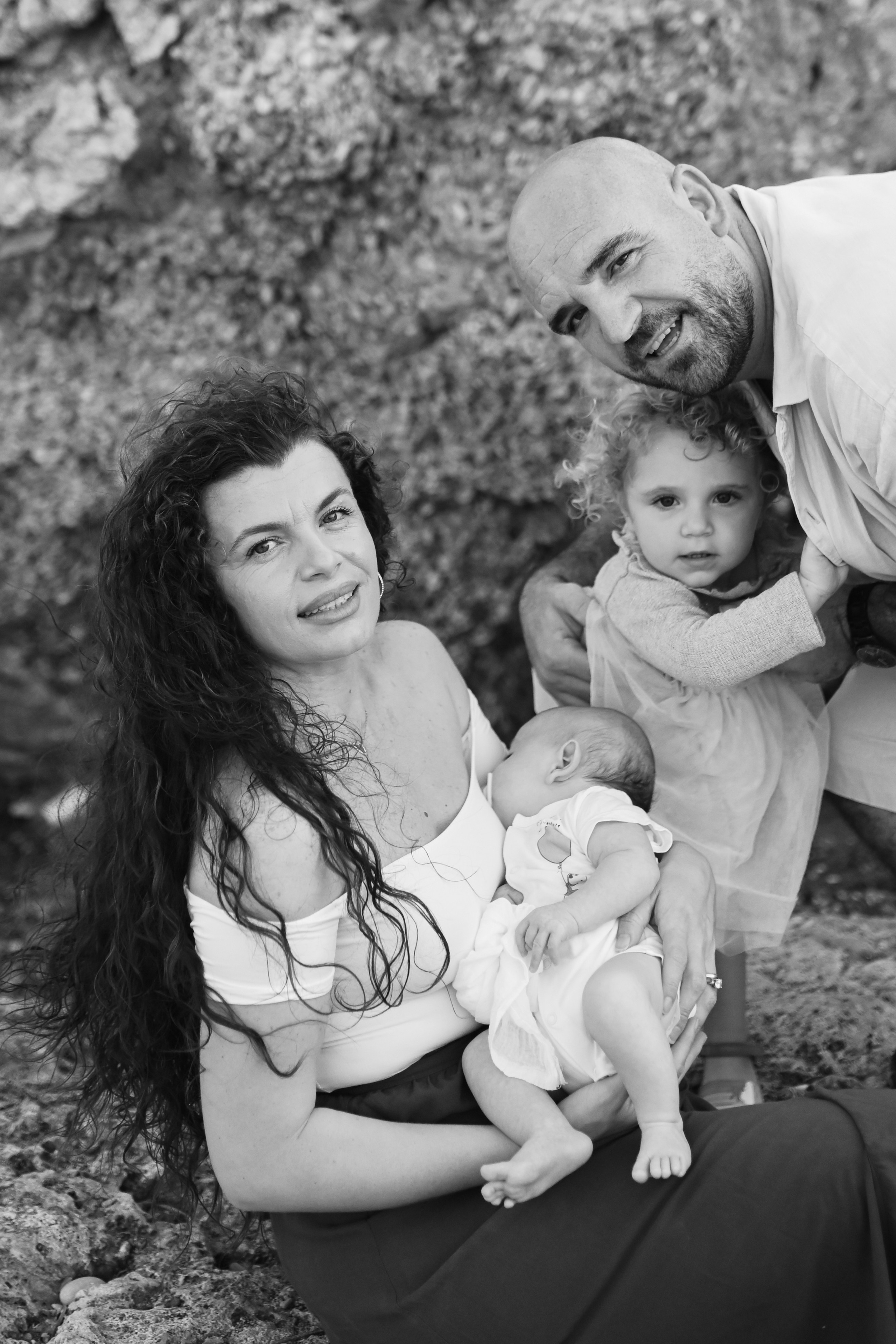 Happy family walking along a Rhodes beach at sunset. Photographer in Rhodes Island
