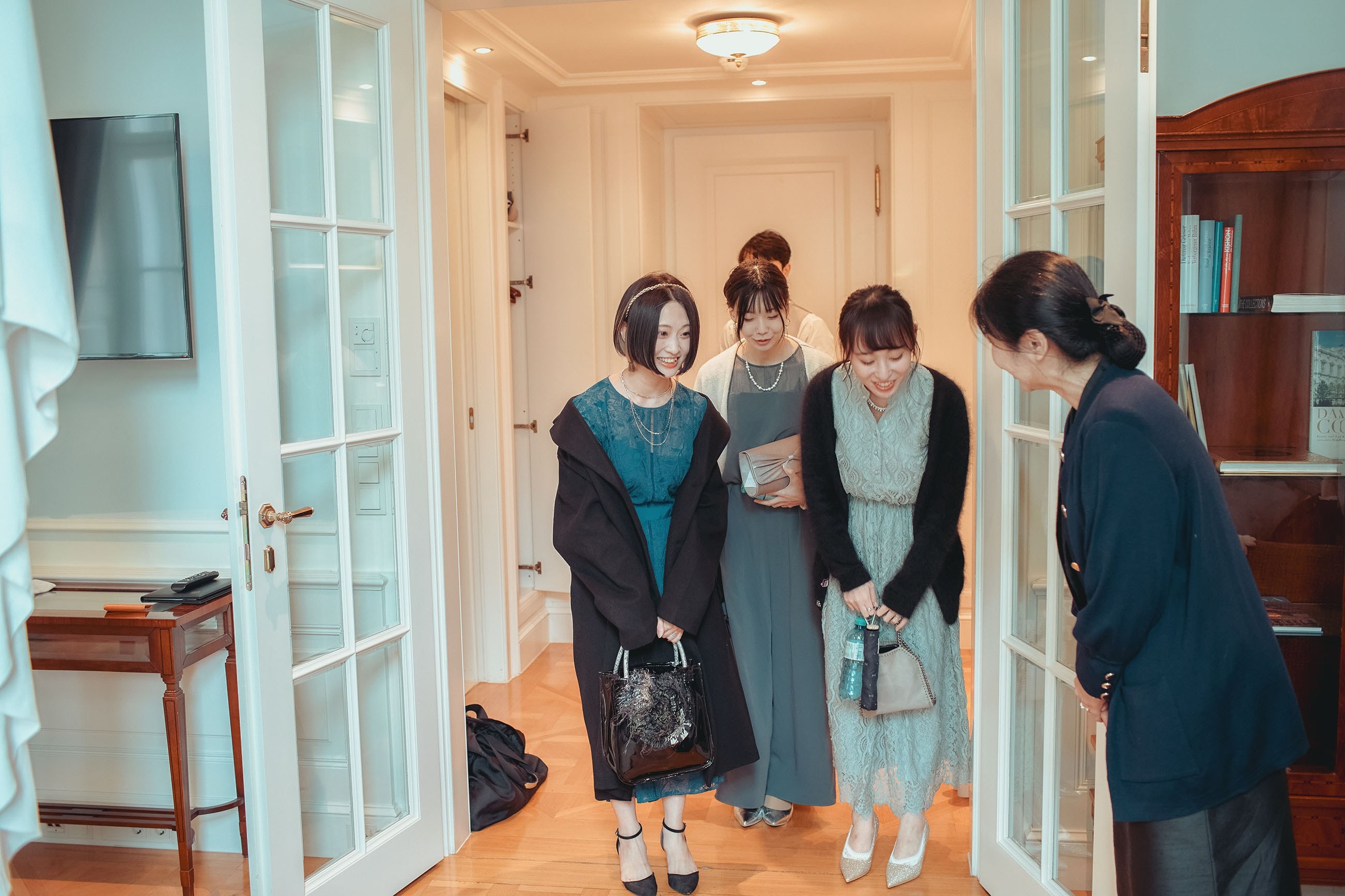 The bride's friends greet her mother at her luxury suite.