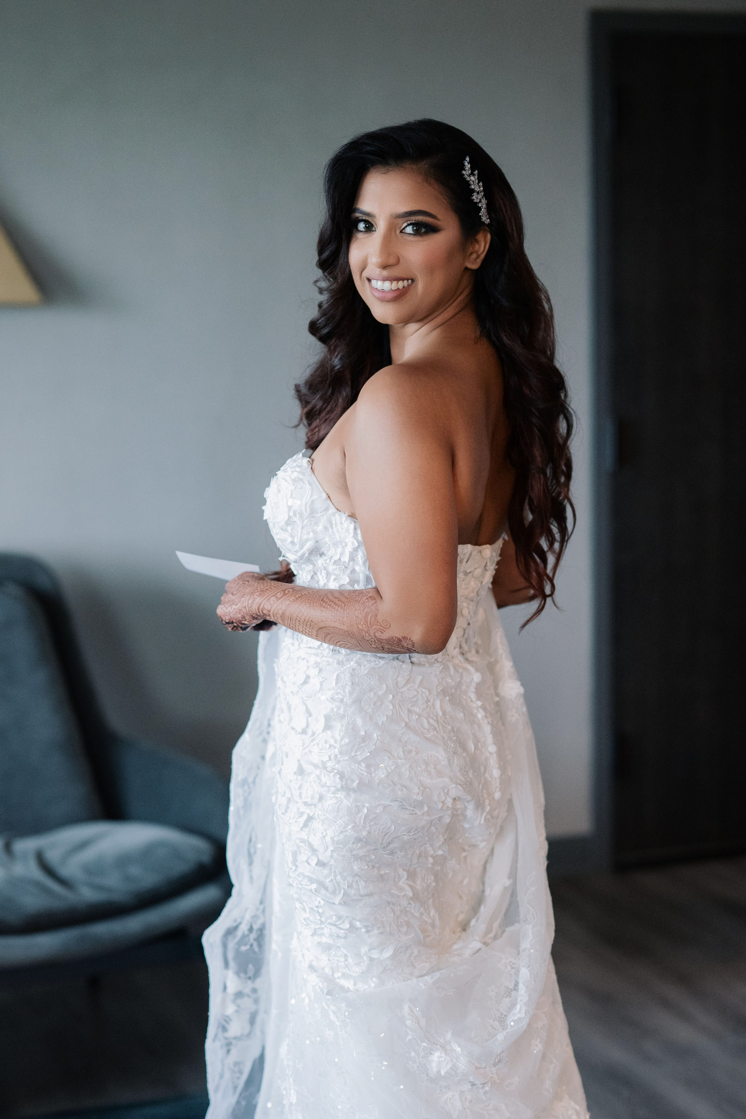 a bride in her wedding dress holding a note