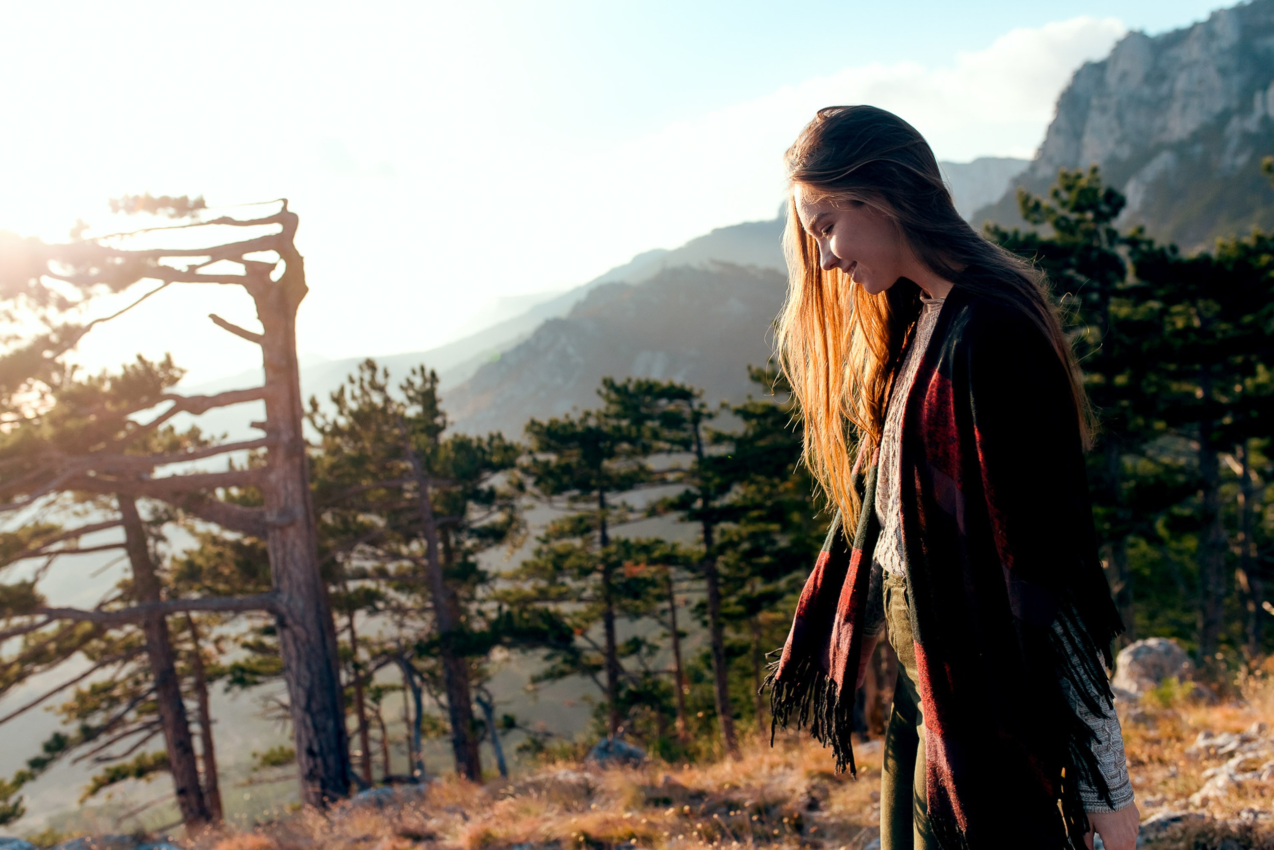 Woman posing by wooden fence at sunset, portrait session