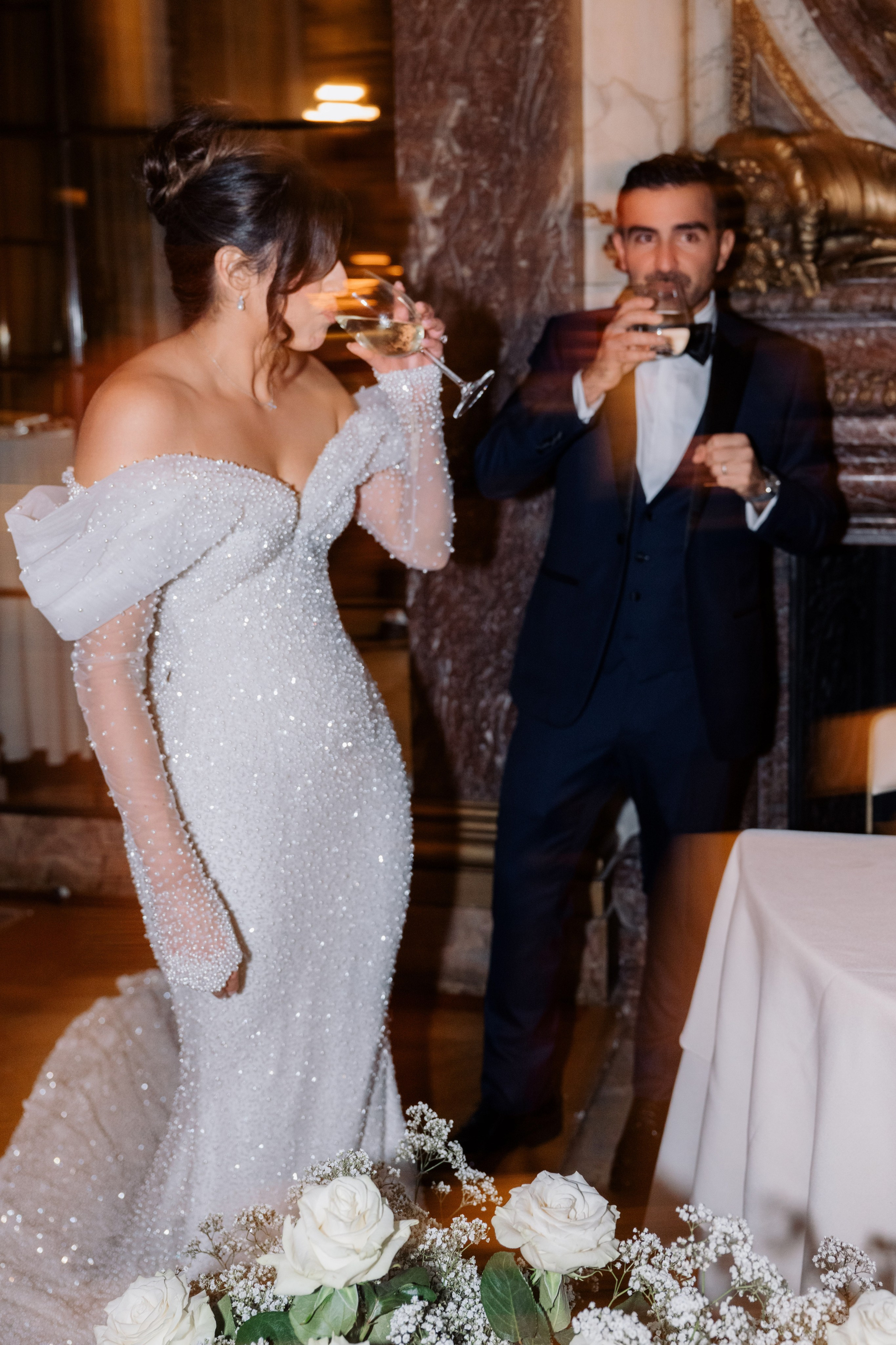 a bride and groom are eating cake at a wedding reception