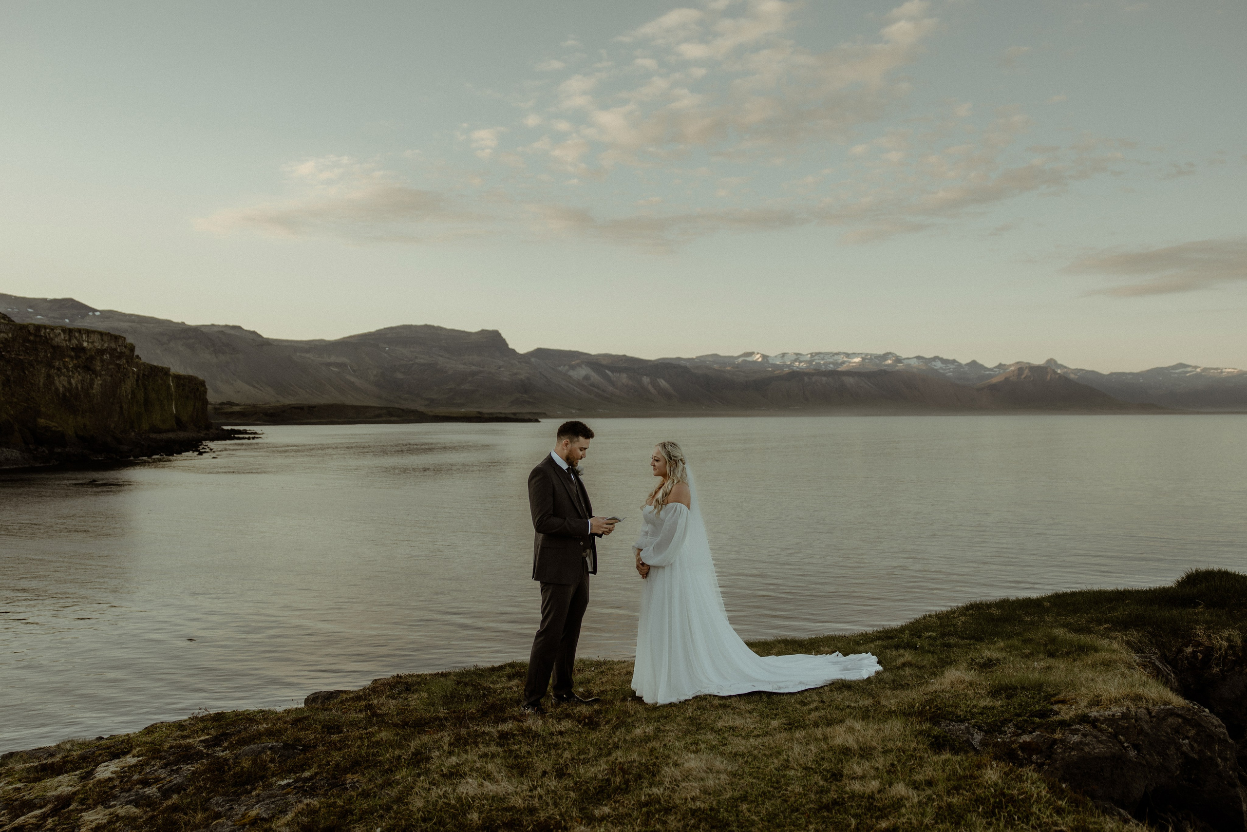 Iceland elopement at Budir with midnight sun wedding photos at black sand beach. Iceland elopement photographer & videographer