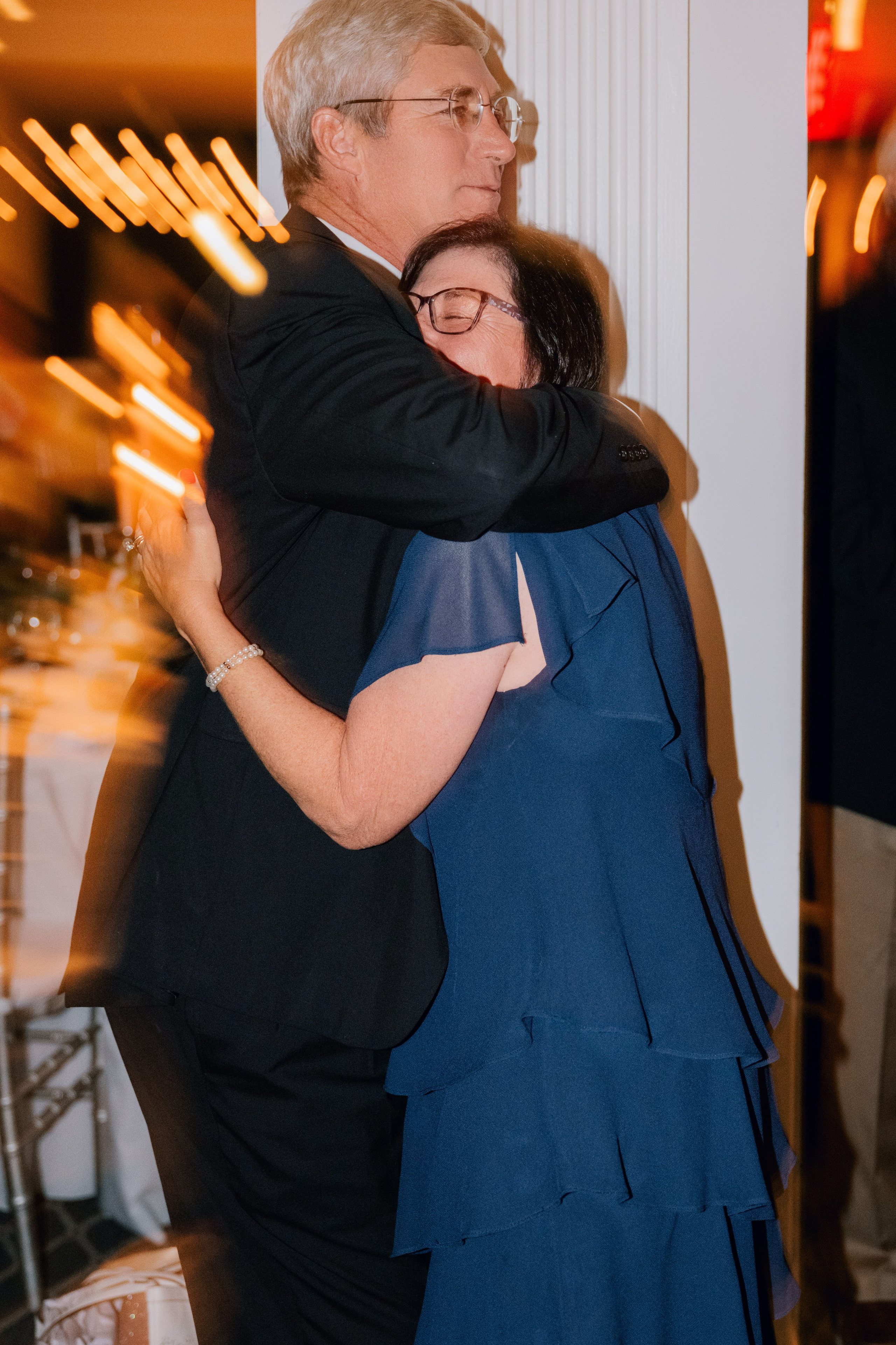 a man and woman hugging each other people