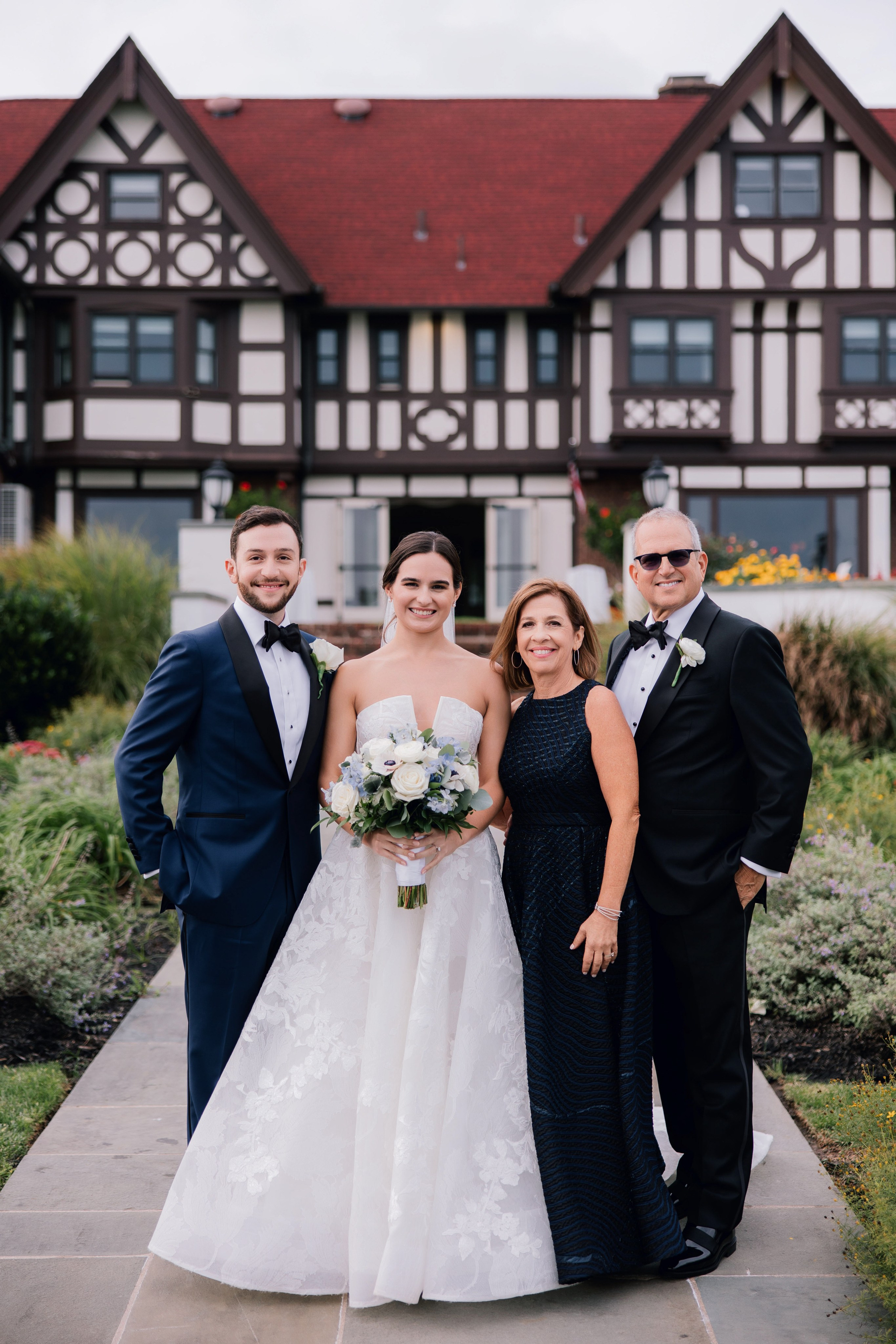 a bride and groom pose for a photo with their bridesmas
