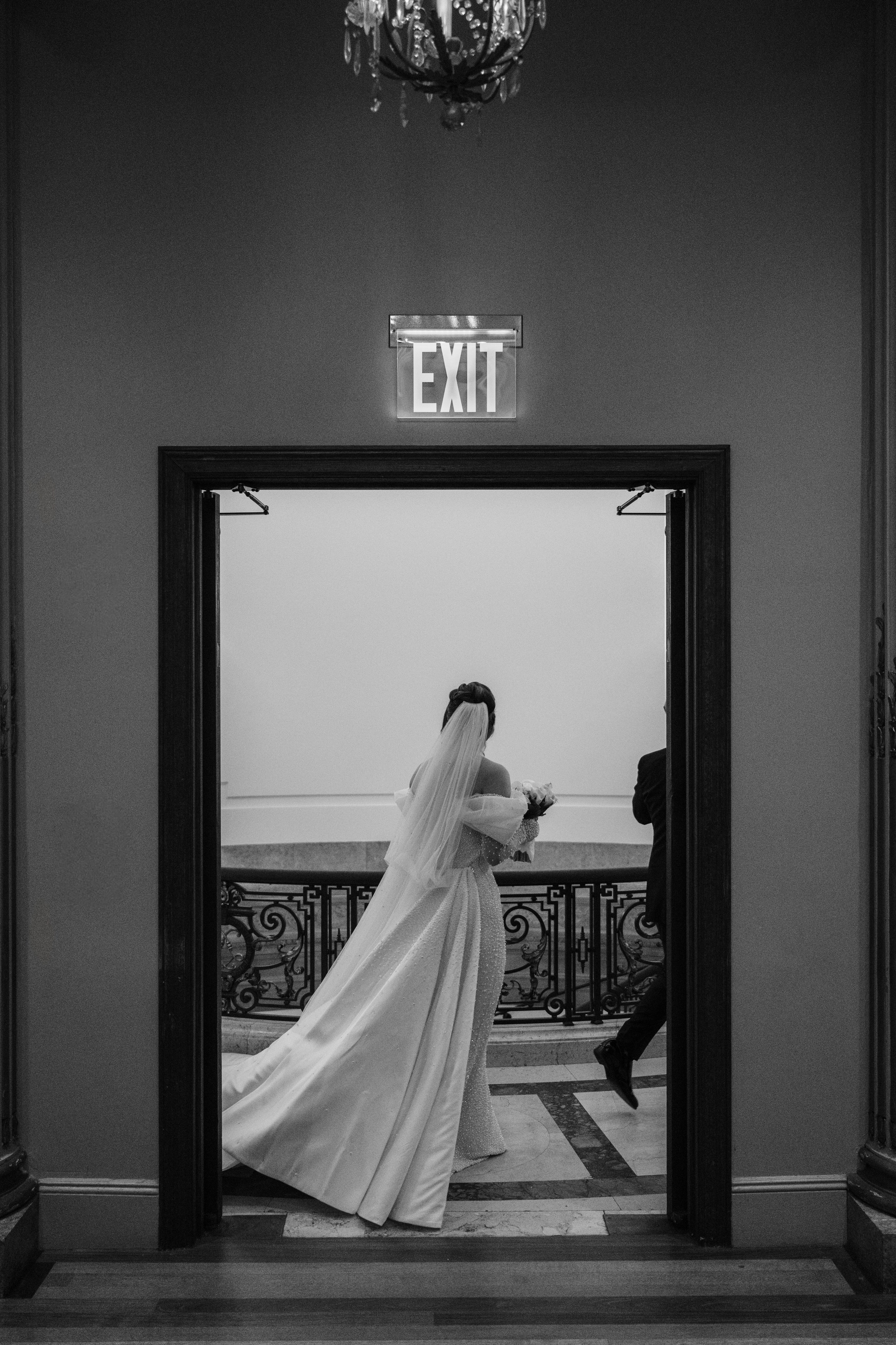 a bride is standing in front of a mirror