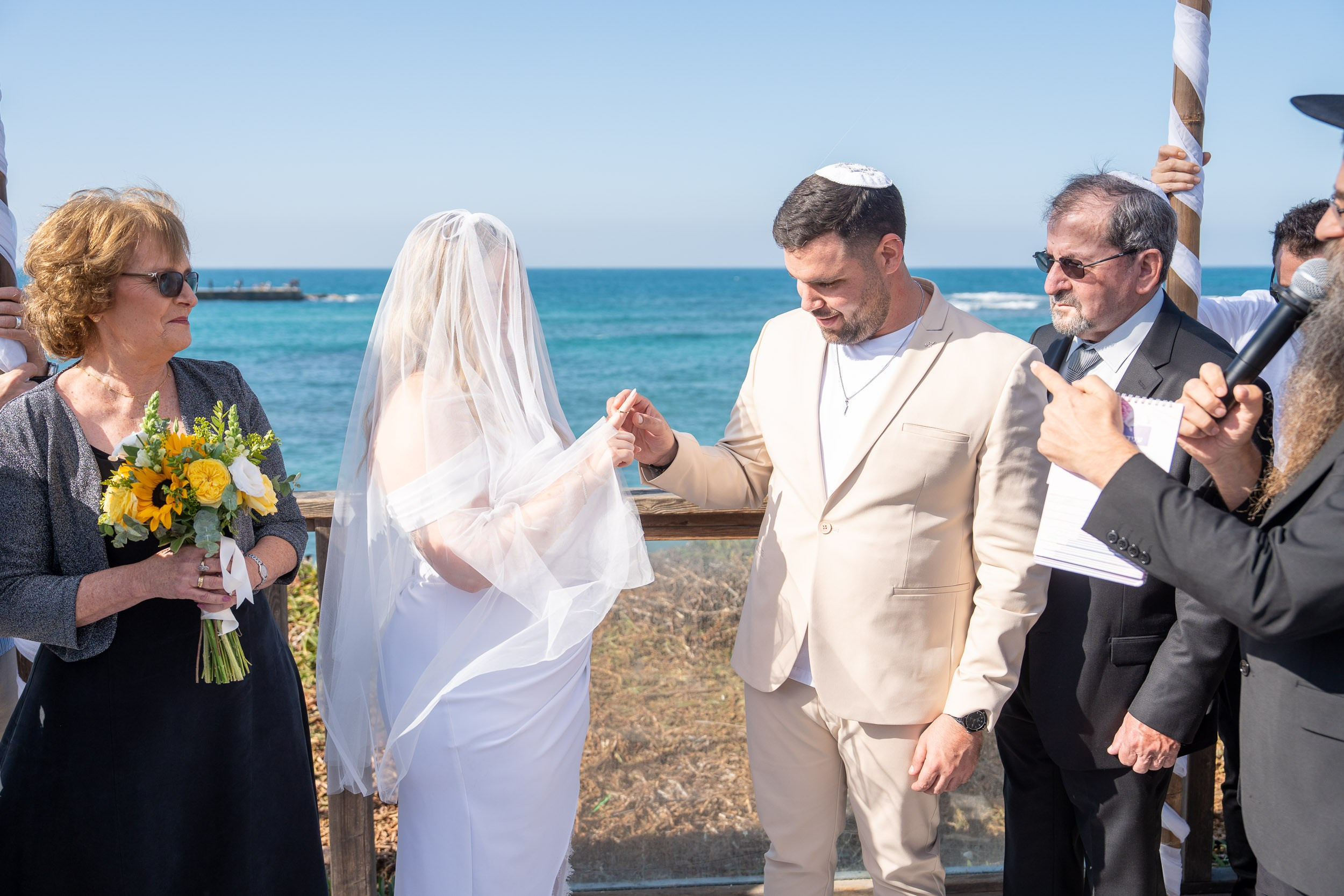Natanel places the wedding ring on Yael’s finger beneath the chuppah