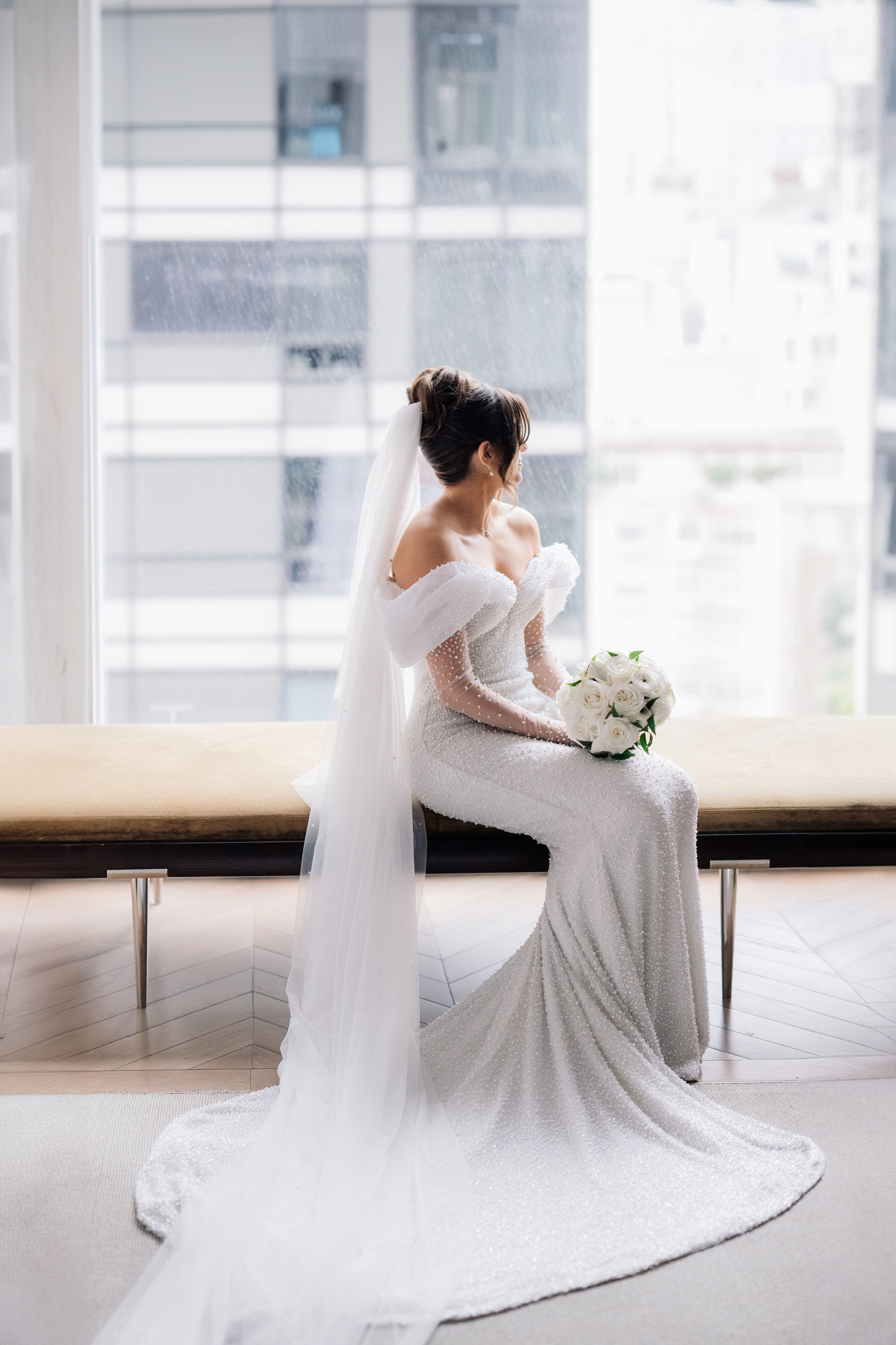 a bride sitting on a bench in a room