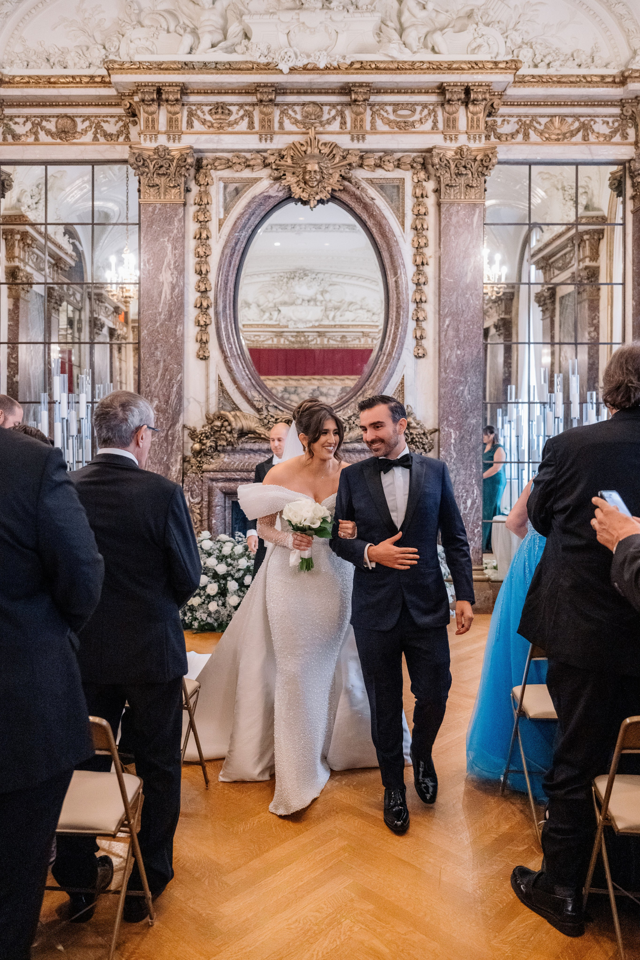 a bride and groom walking down the aisle