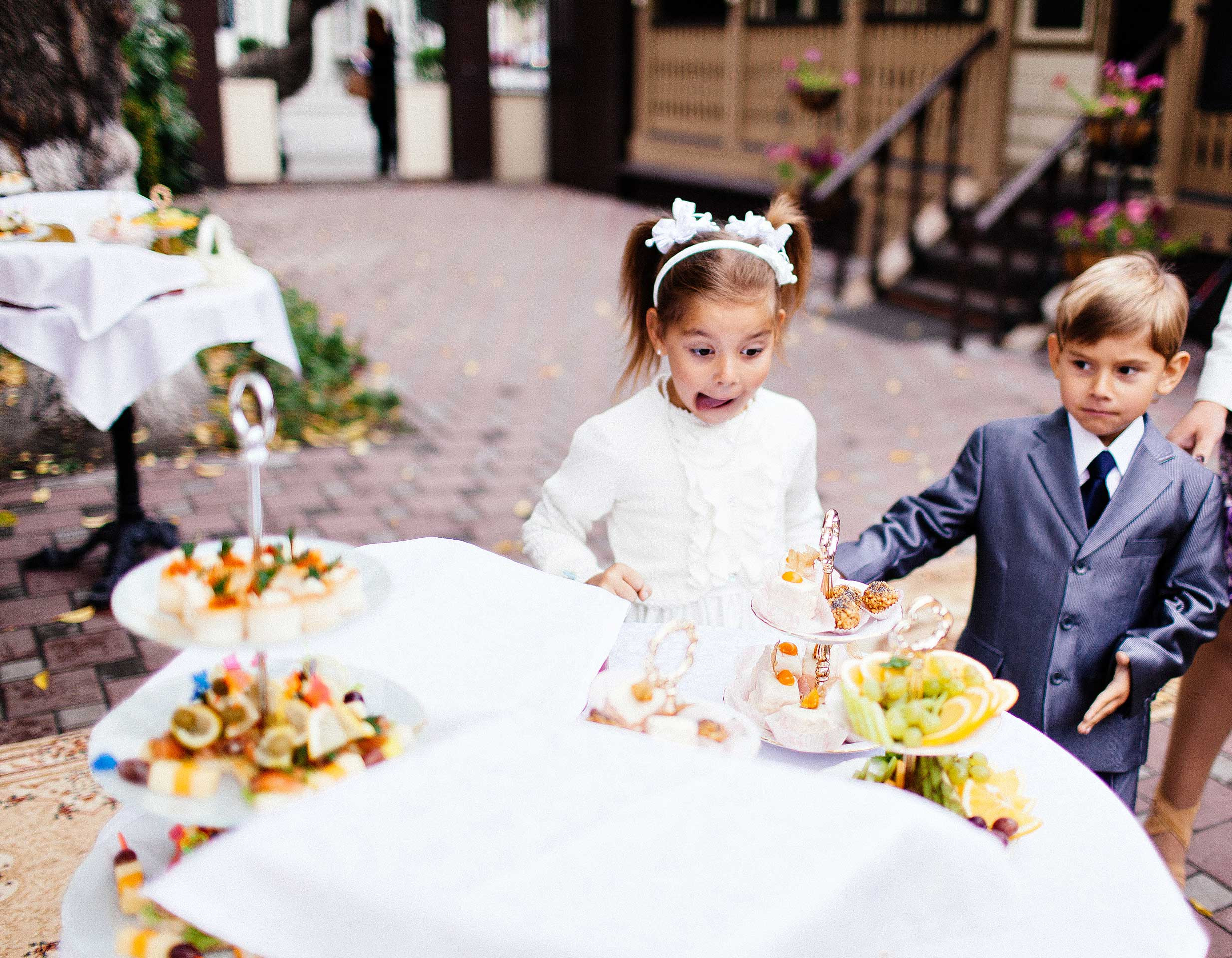 Boy and girl surprised by the wedding cake